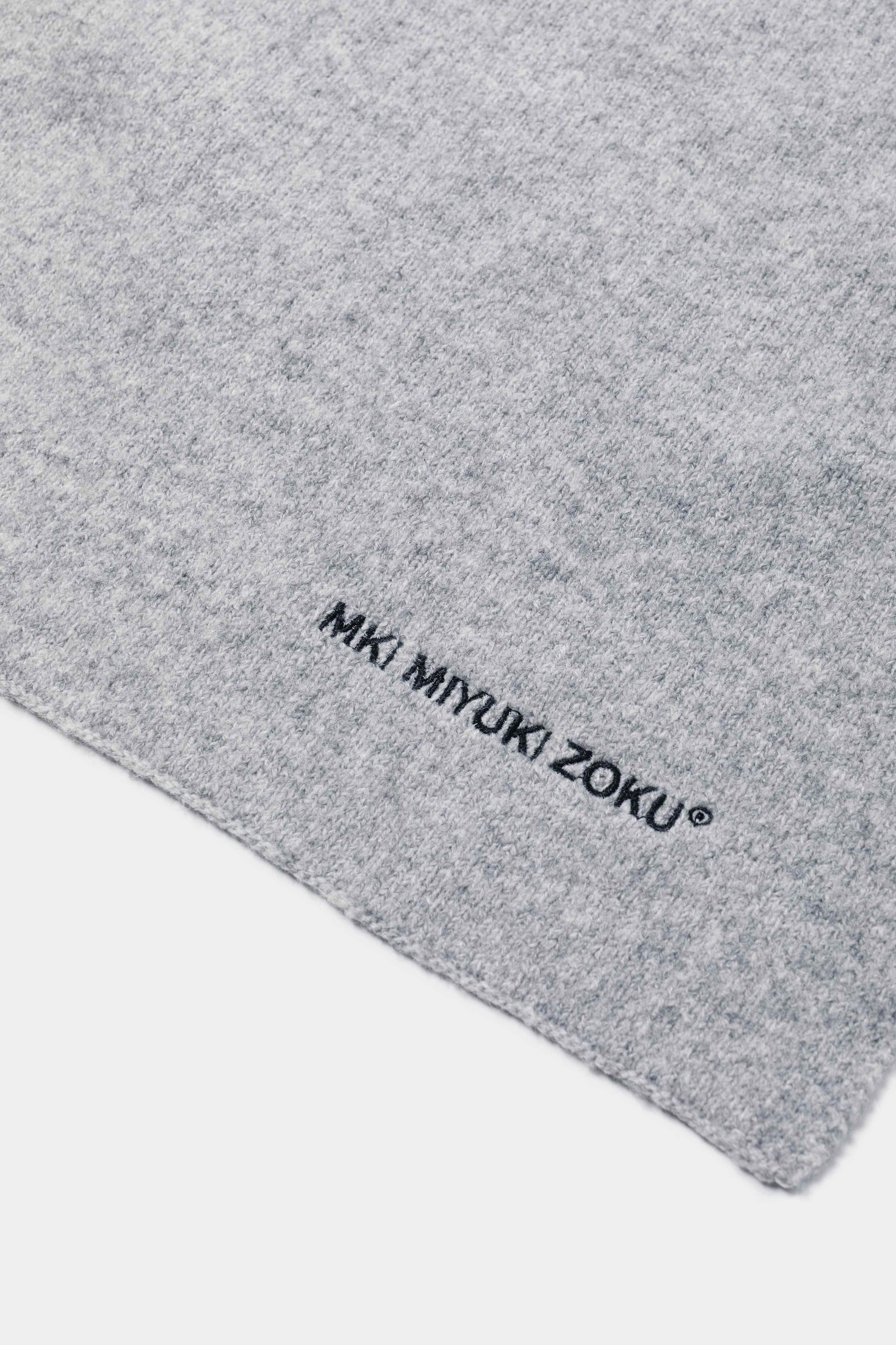 Close-up of the black MKI MIYUKI ZOKU logo embroidered on the Ash double knit wool blend