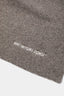 Close-up of the white MKI MIYUKI ZOKU logo embroidered on the Brown double knit wool blend