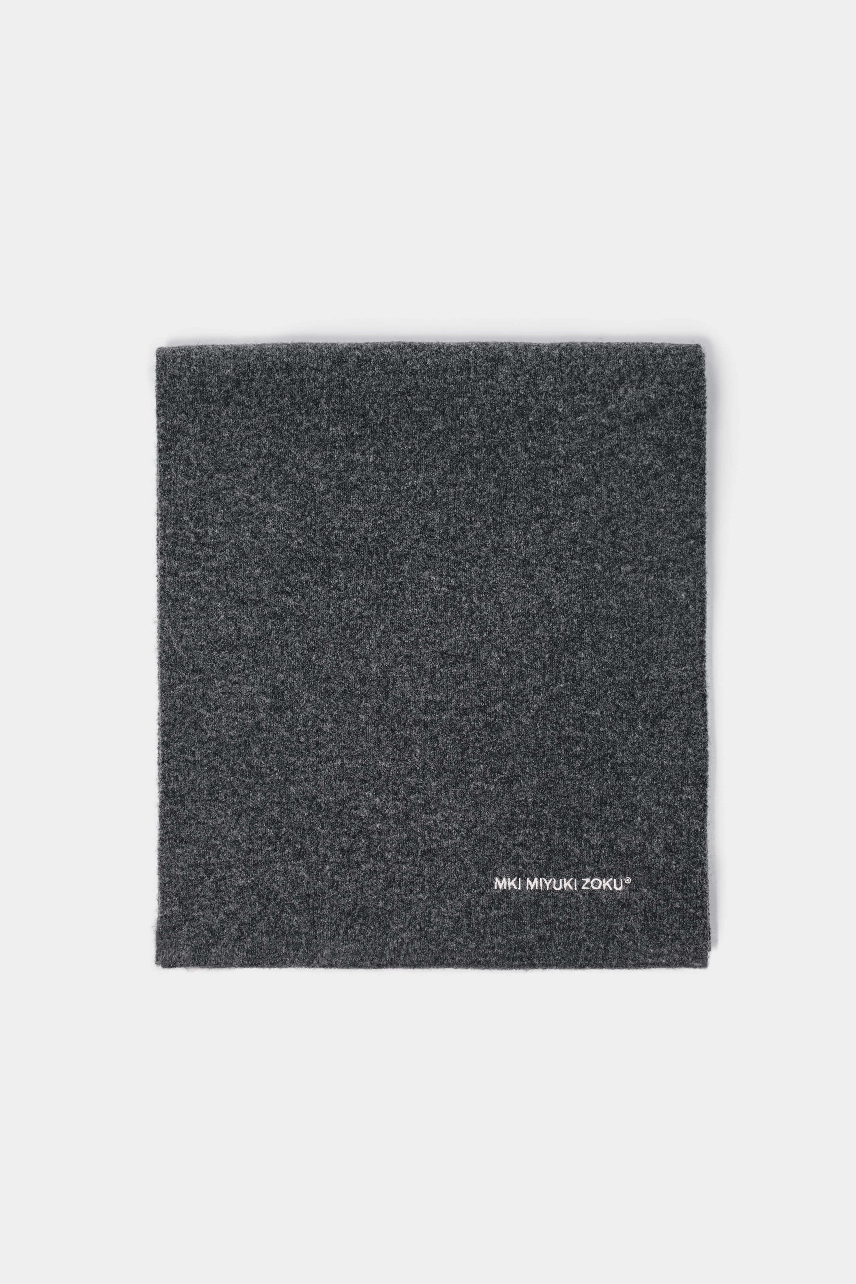 Folded flat lay of the Charcoal double knit scarf showing the white logo embroidery at the corner
