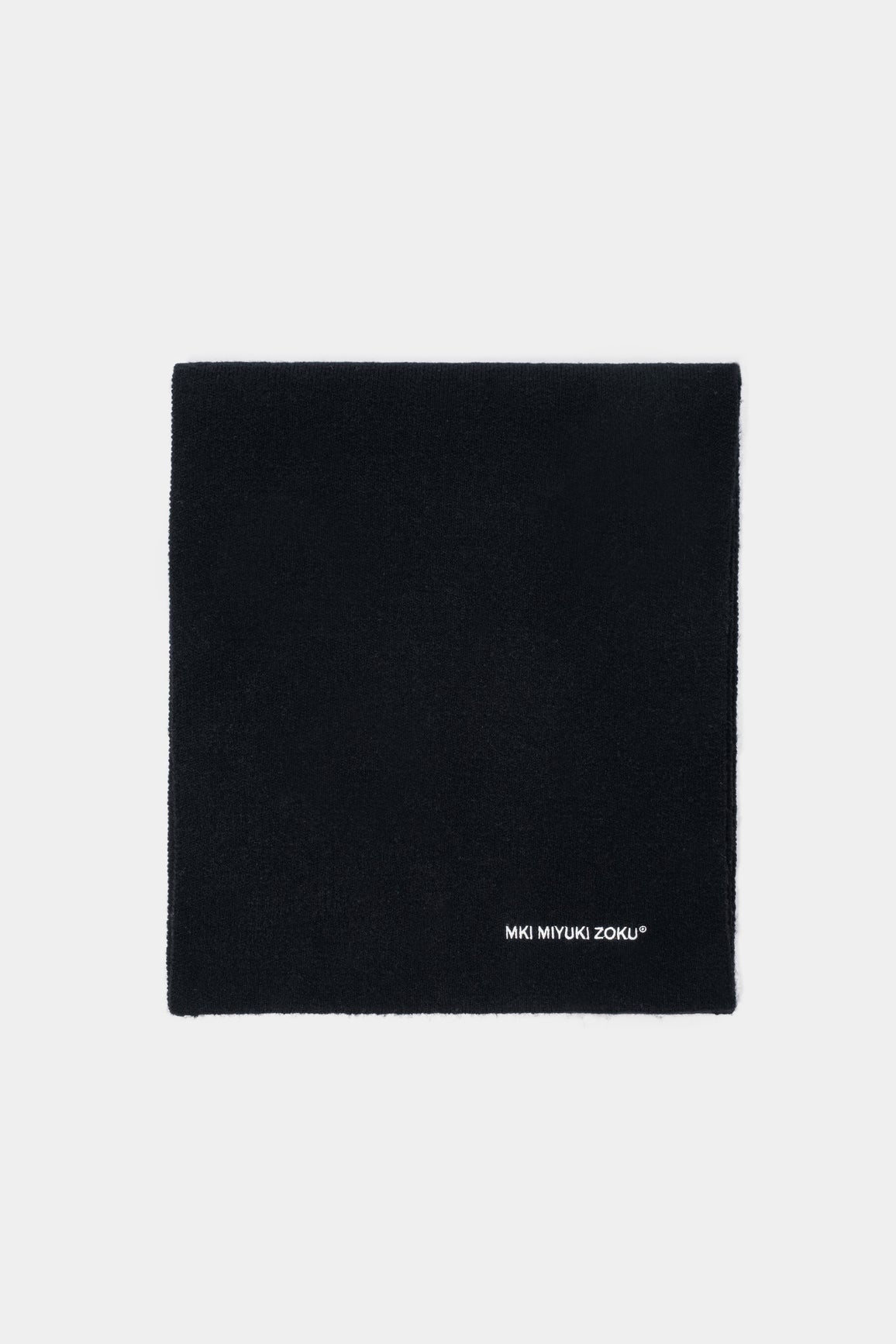 Folded flat lay of the Black double knit scarf showing the white logo embroidery at the corner
