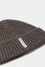 Close-up of the woven MKI MIYUKI ZOKU tag and heavy rib knit on the Brown cashmere beanie