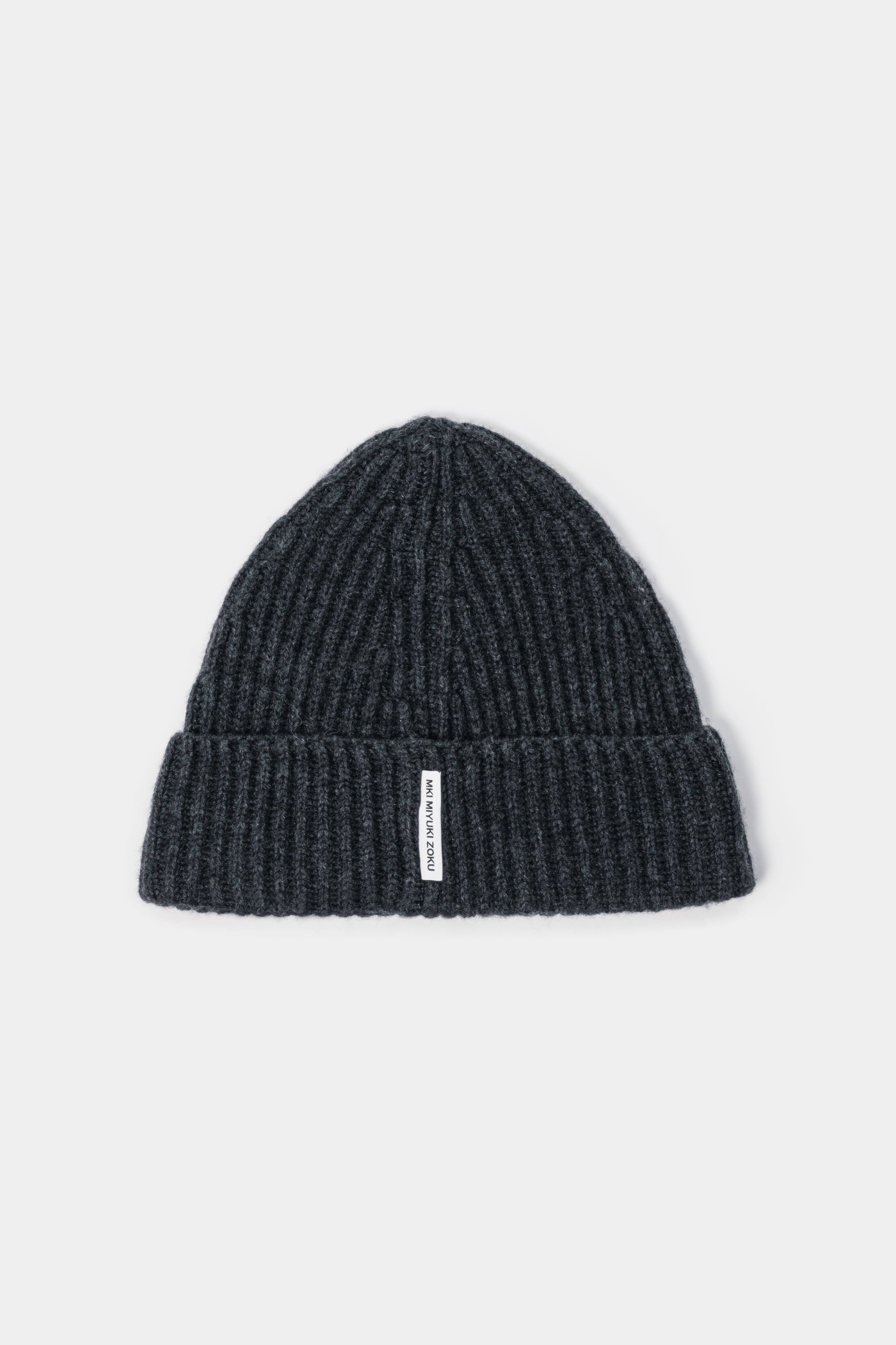 MKI MIYUKI ZOKU Cashmere Ribbed Beanie in Charcoal – front view showing the heavy gauge rib, single turn-up and woven MKI MIYUKI ZOKU tag