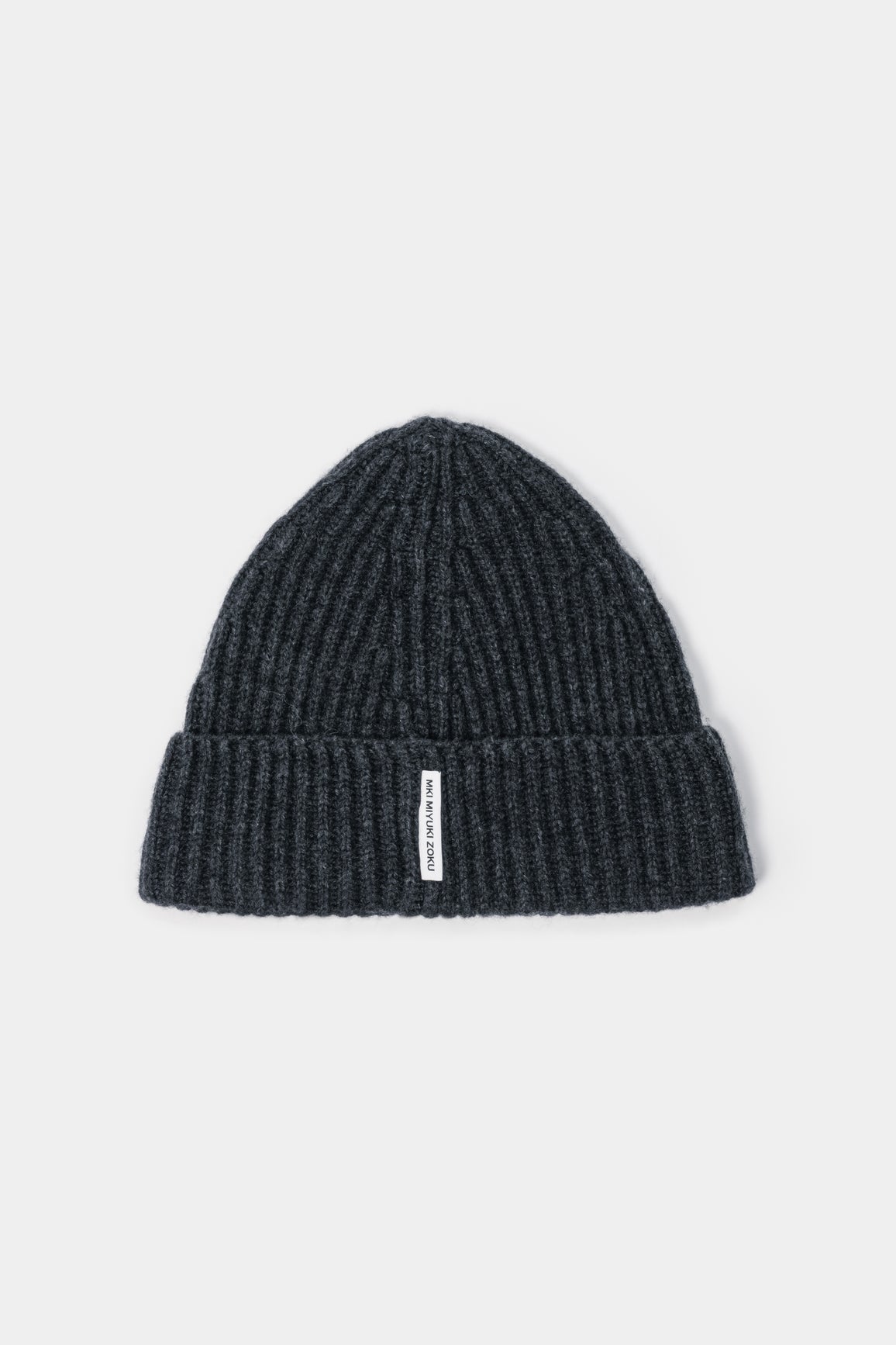 MKI MIYUKI ZOKU Cashmere Ribbed Beanie in Charcoal – front view showing the heavy gauge rib, single turn-up and woven MKI MIYUKI ZOKU tag