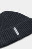 Close-up of the woven MKI MIYUKI ZOKU tag and heavy rib knit on the Charcoal cashmere beanie