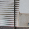 Metal roller shutter door next to a concrete wall