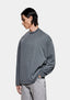 Three-quarter view of the boxy Pigment Black long sleeve T-shirt showing its washed, faded charcoal tone