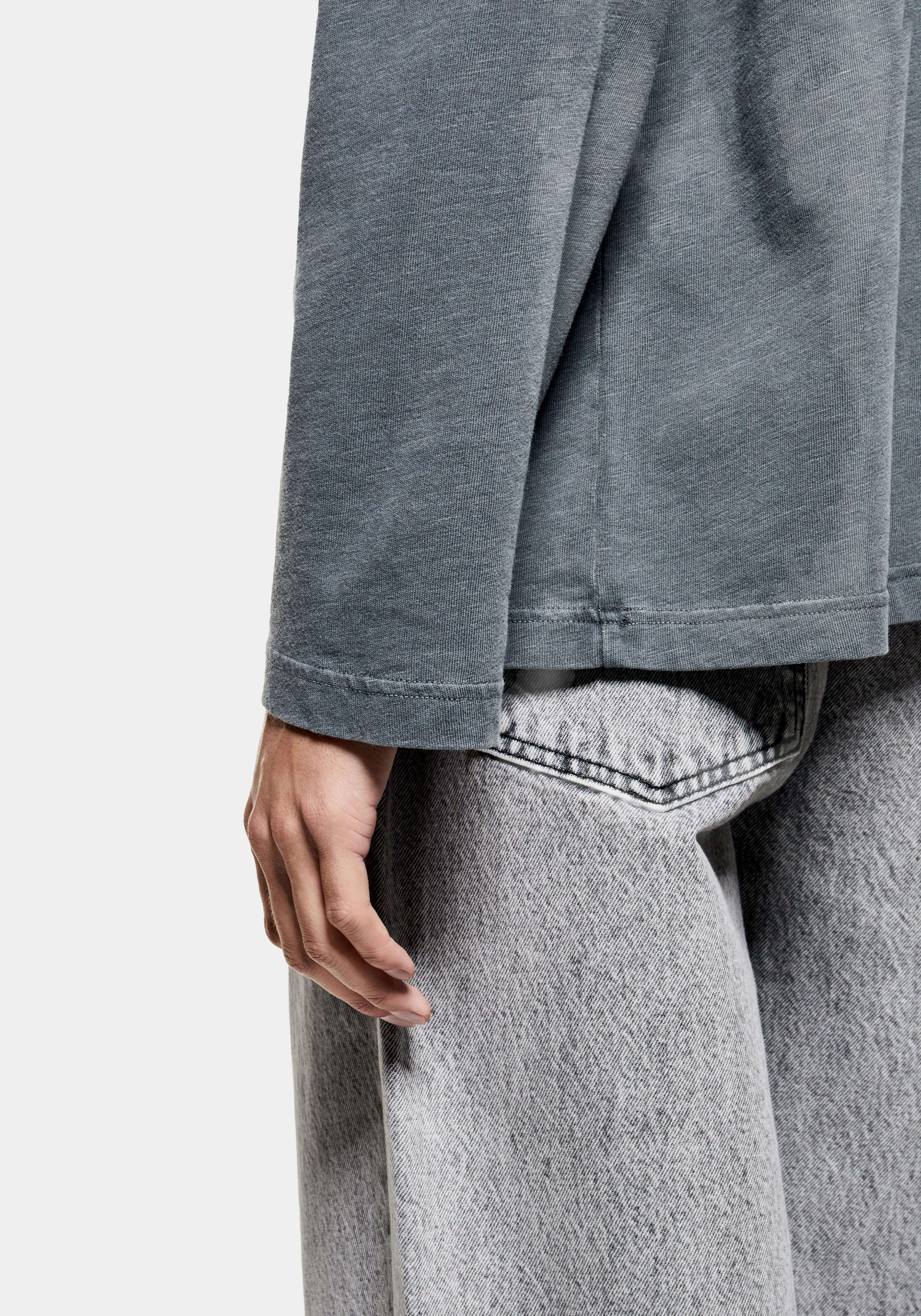 Close-up of the long sleeve and faded open cuff at the wrist