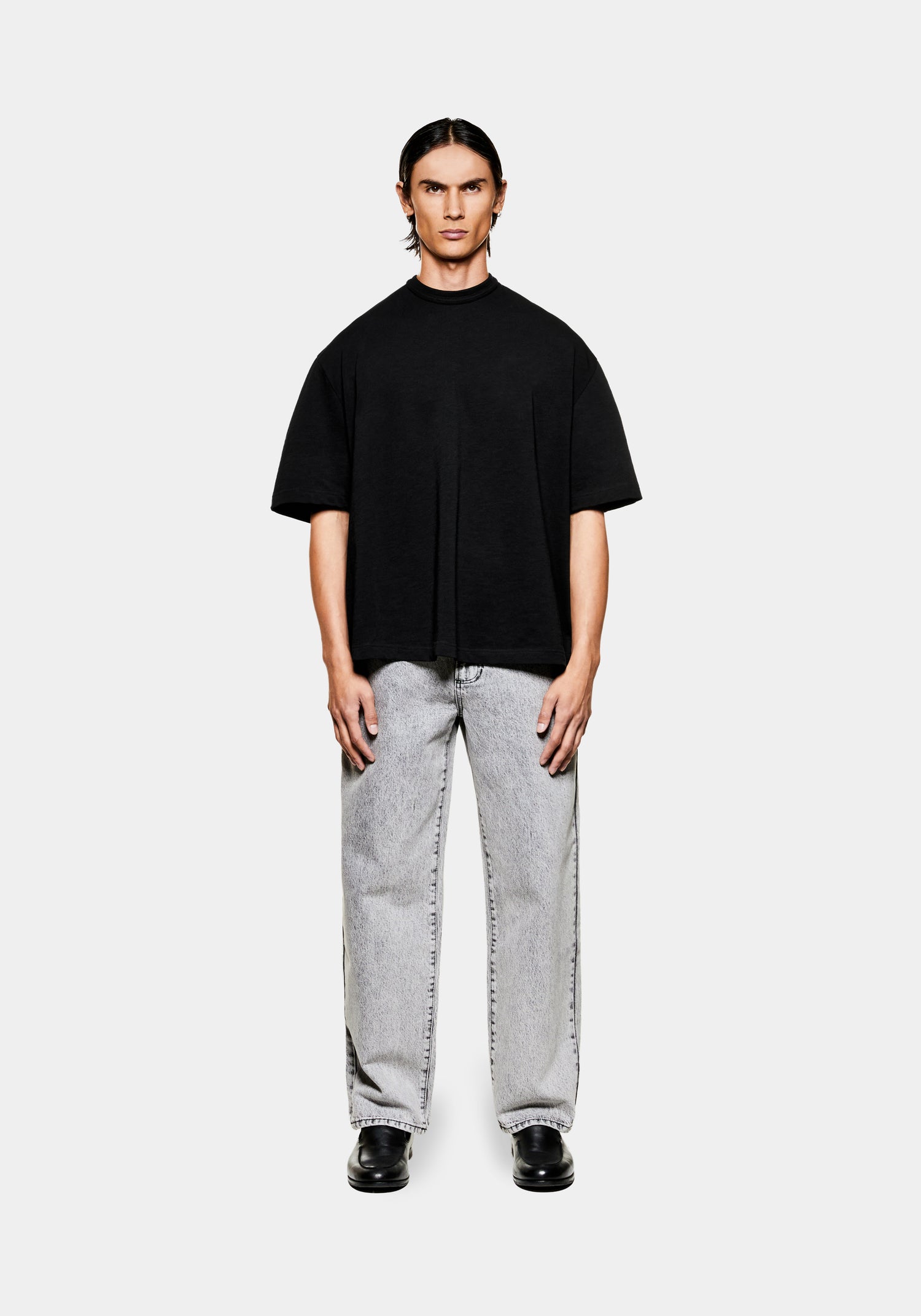 Full view of the men's black  MKI 220gsm cotton slub jersey t-shirt in a boxy cropped fit