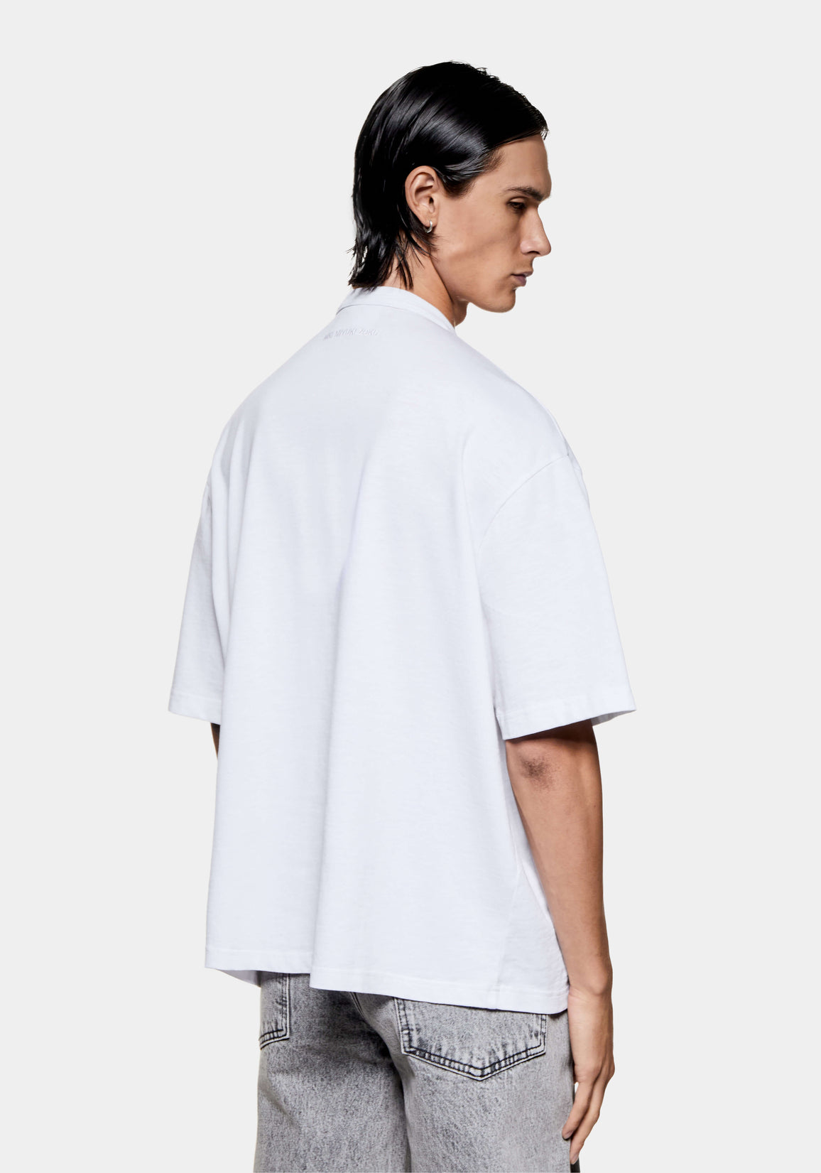Back view of the white slub T-shirt on the model, showing the relaxed box fit