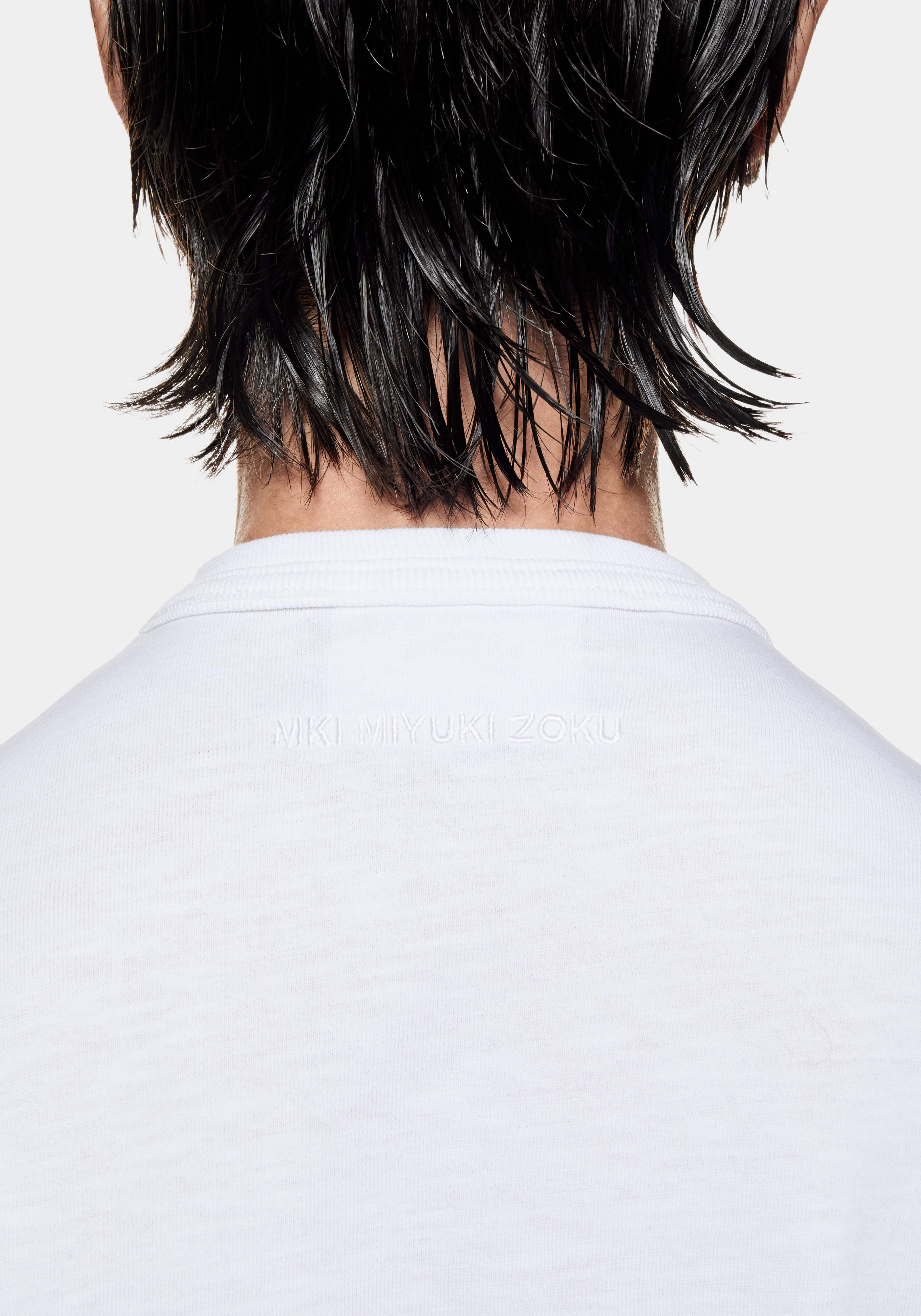 Close-up of the tonal MKI MIYUKI ZOKU logo embroidered below the back neck