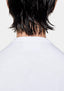 Close-up of the tonal MKI MIYUKI ZOKU logo embroidered below the back neck