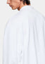 Close-up of the dropped shoulder seam and textured slub jersey on the white T-shirt