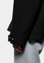 Close-up of the sleeve cuff with press stud