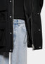 Close-up of the two-way zip and press stud placket