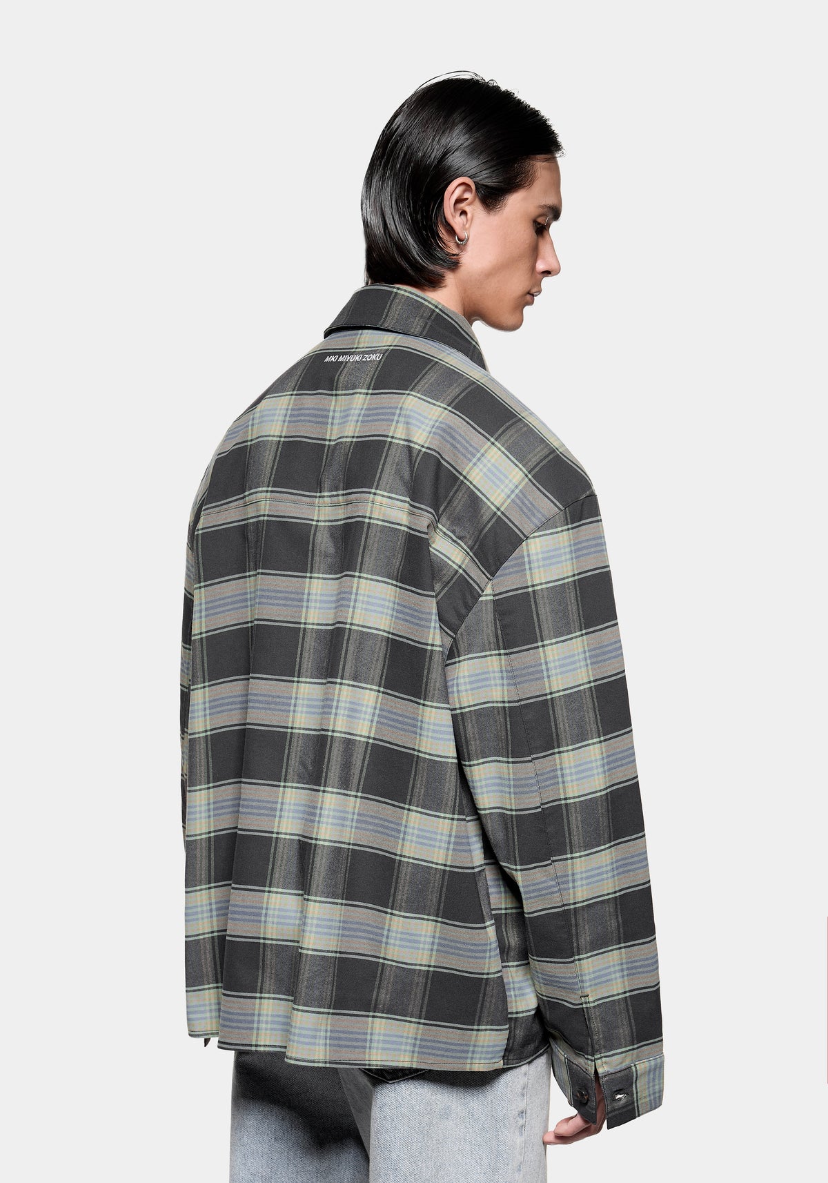 Close-up of the MKI MIYUKI ZOKU logo embroidery at the back collar on the Box Dress Shirt in Blue Check