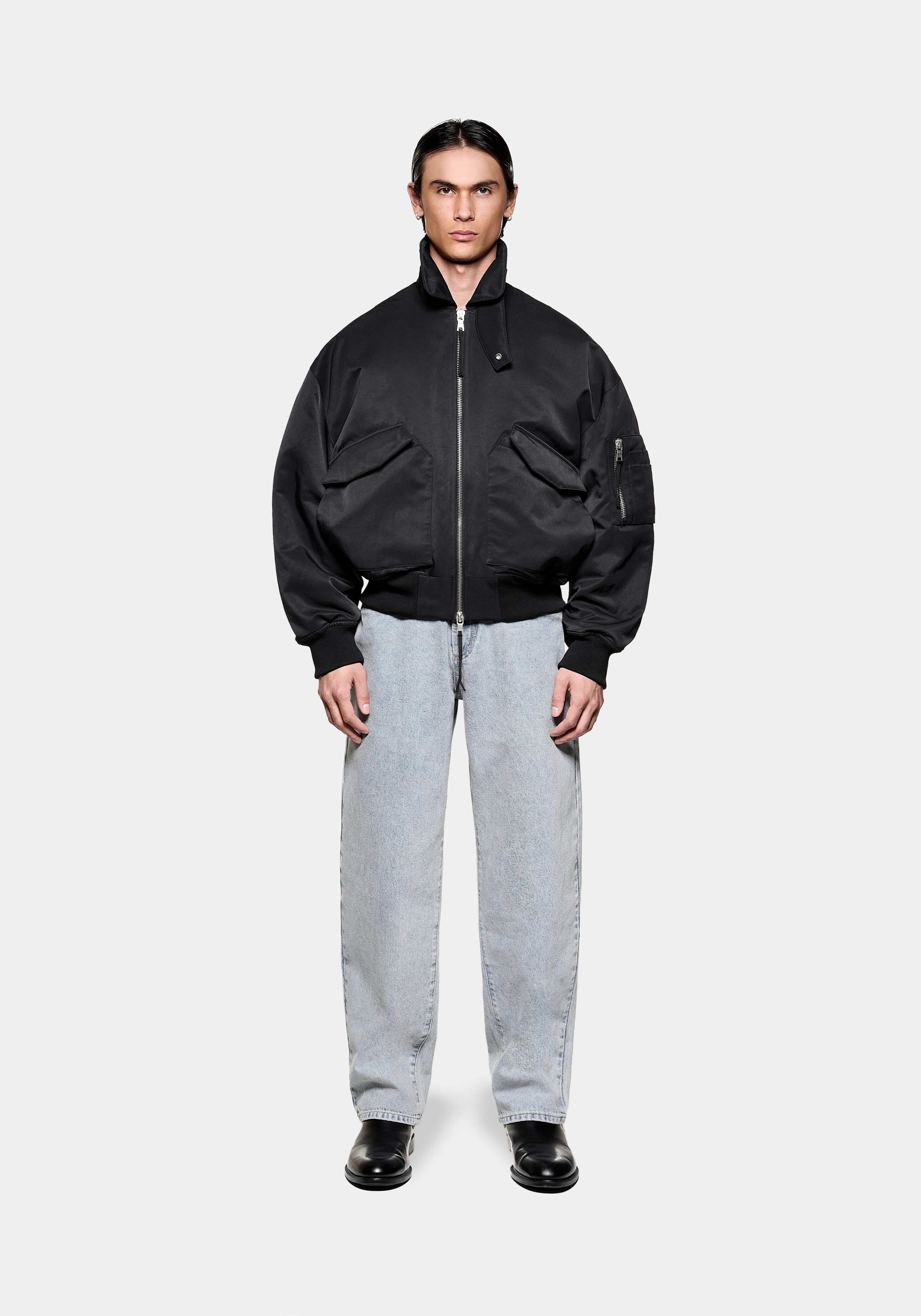 MKI MIYUKI ZOKU Padded MA2 Bomber Jacket in Black, front view with the collar up, styled with bleach wash jeans
