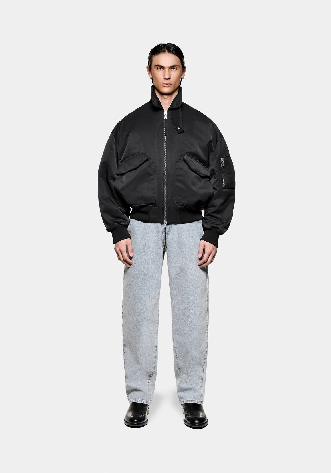 MKI MIYUKI ZOKU Padded MA2 Bomber Jacket in Black, front view with the collar up, styled with bleach wash jeans