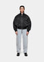 MKI MIYUKI ZOKU Padded MA2 Bomber Jacket in Black, front view with the collar up, styled with bleach wash jeans