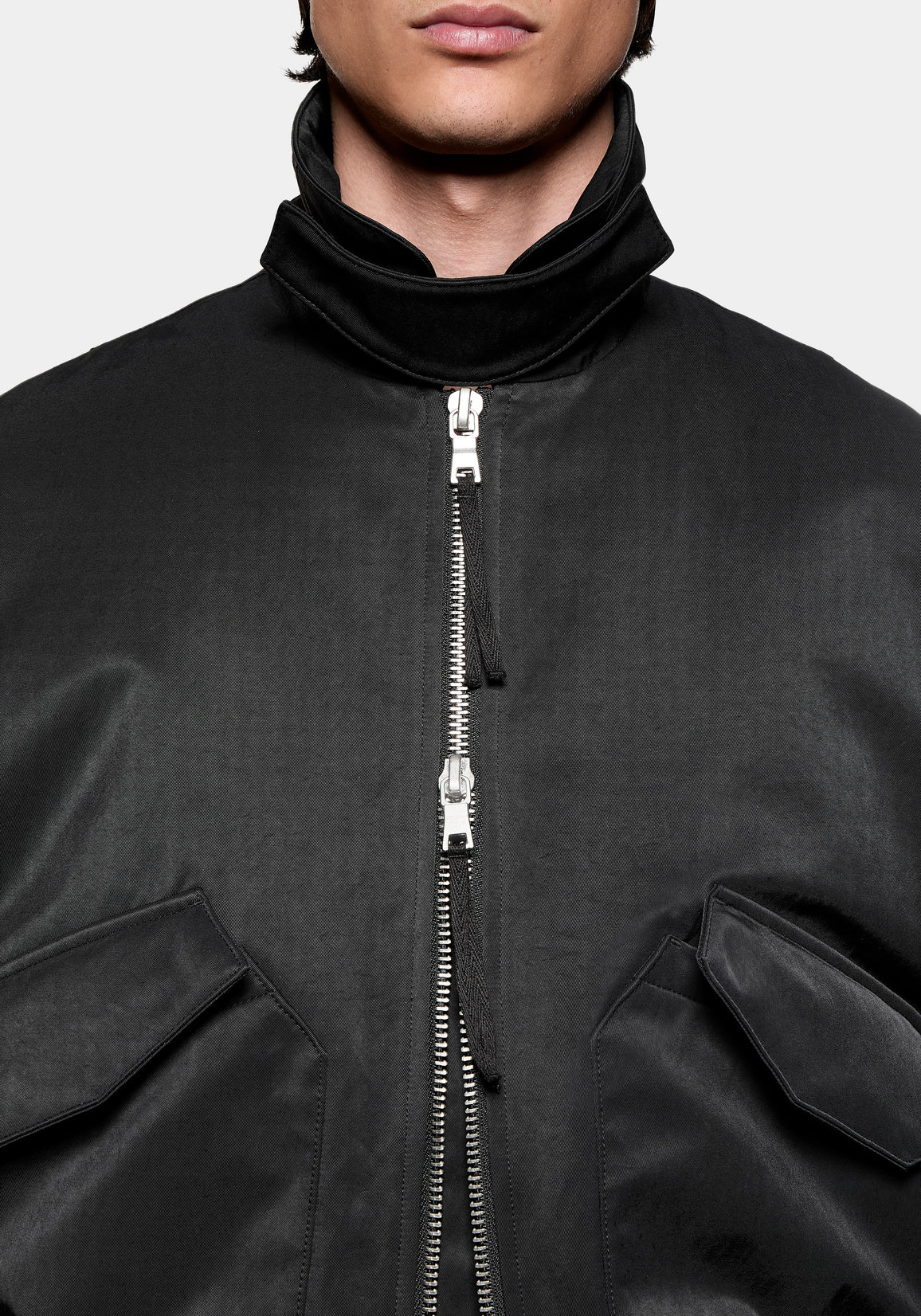 Close-up of the high collar and two-way zip