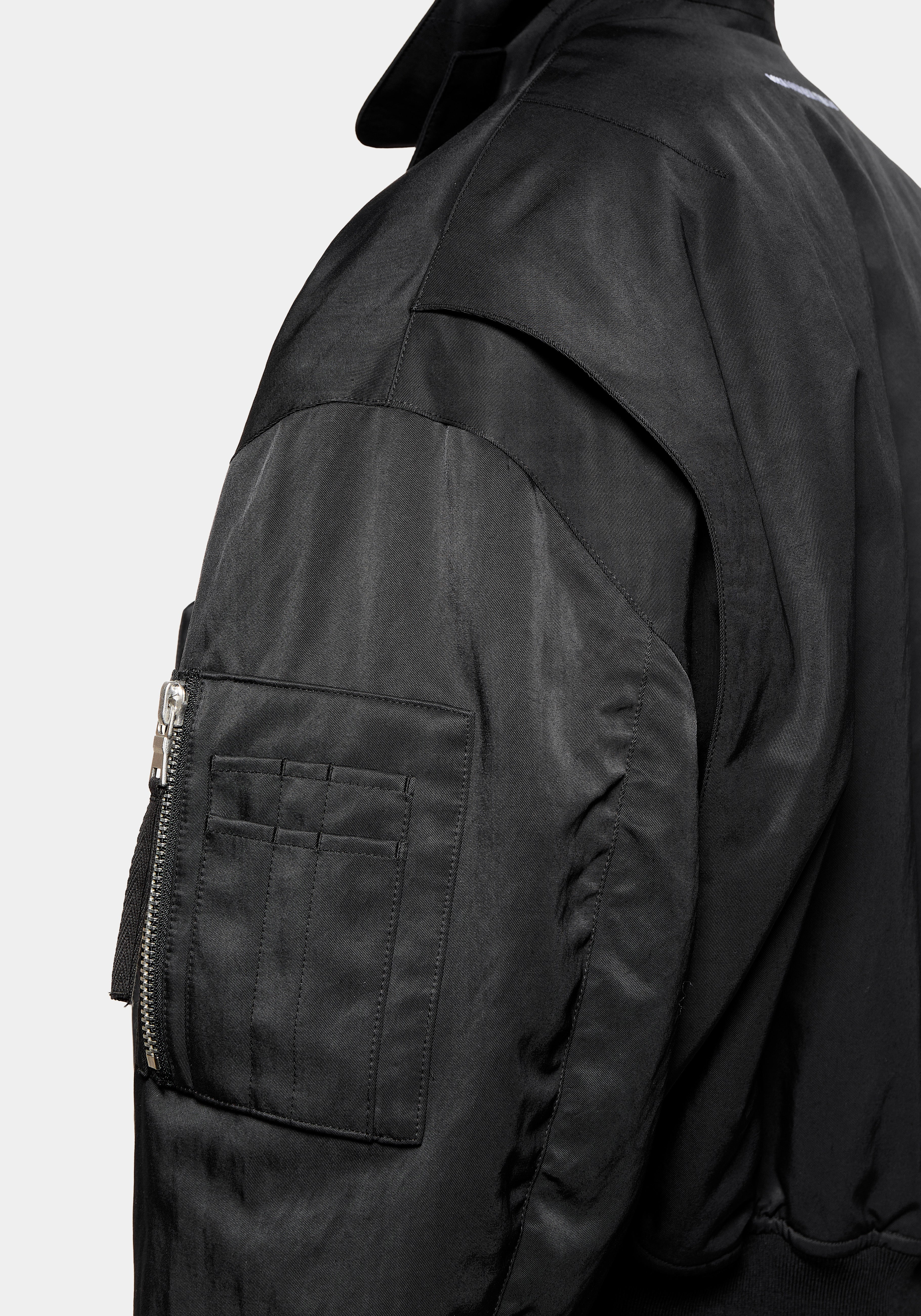 Close-up of the sleeve pen pocket and zip detail