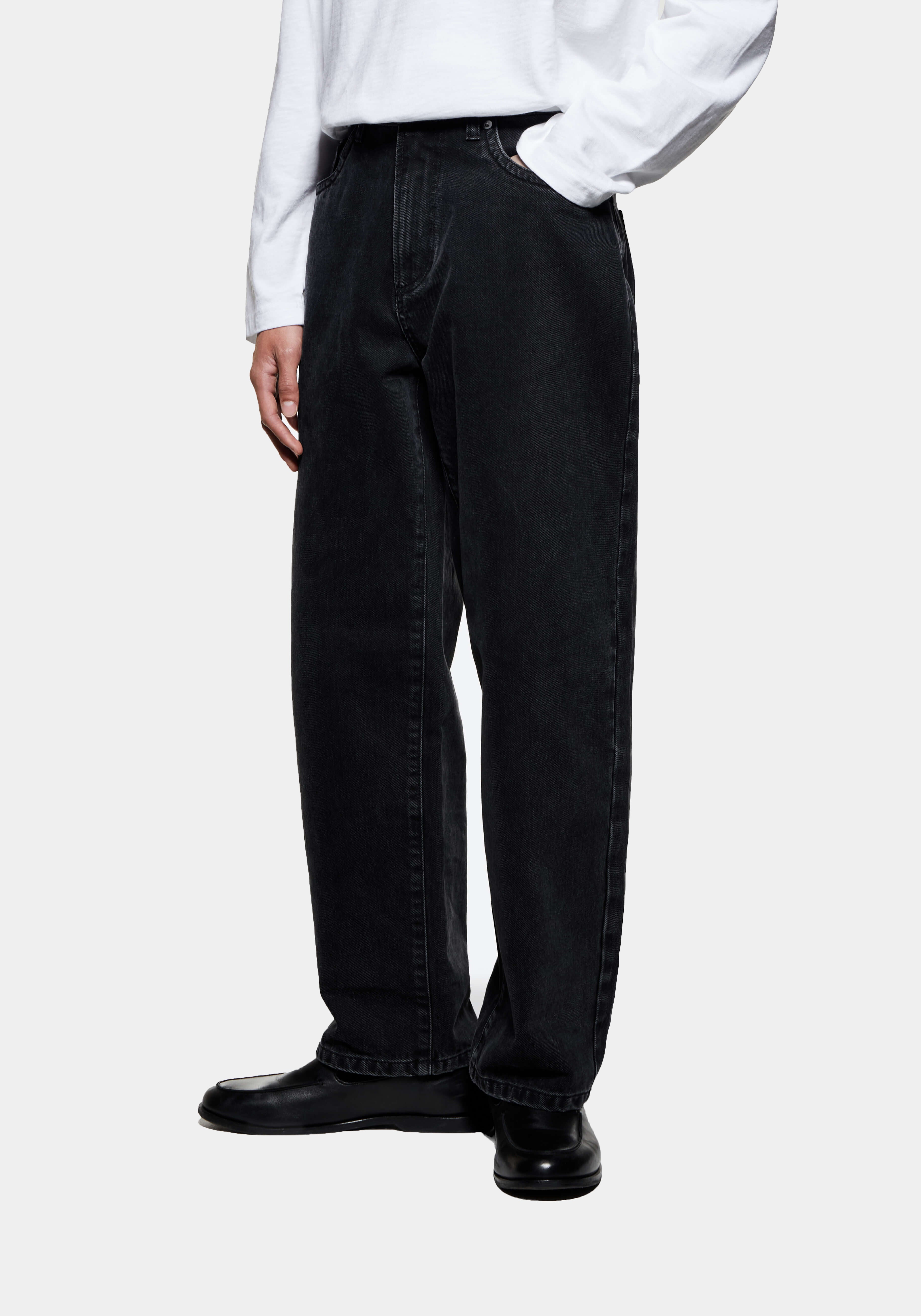 Three-quarter view of the Black Wash jeans showing the classic straight leg from hip to hem