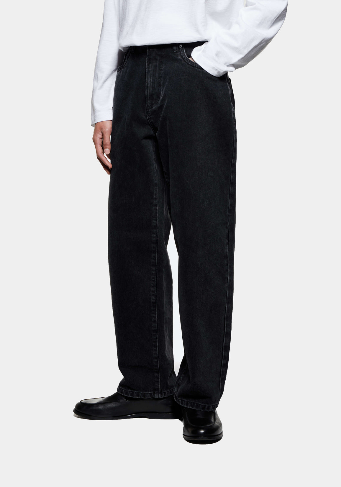Three-quarter view of the Black Wash jeans showing the classic straight leg from hip to hem