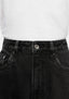 Close-up of the waistband, donut button and five-pocket front of the Black Wash jeans