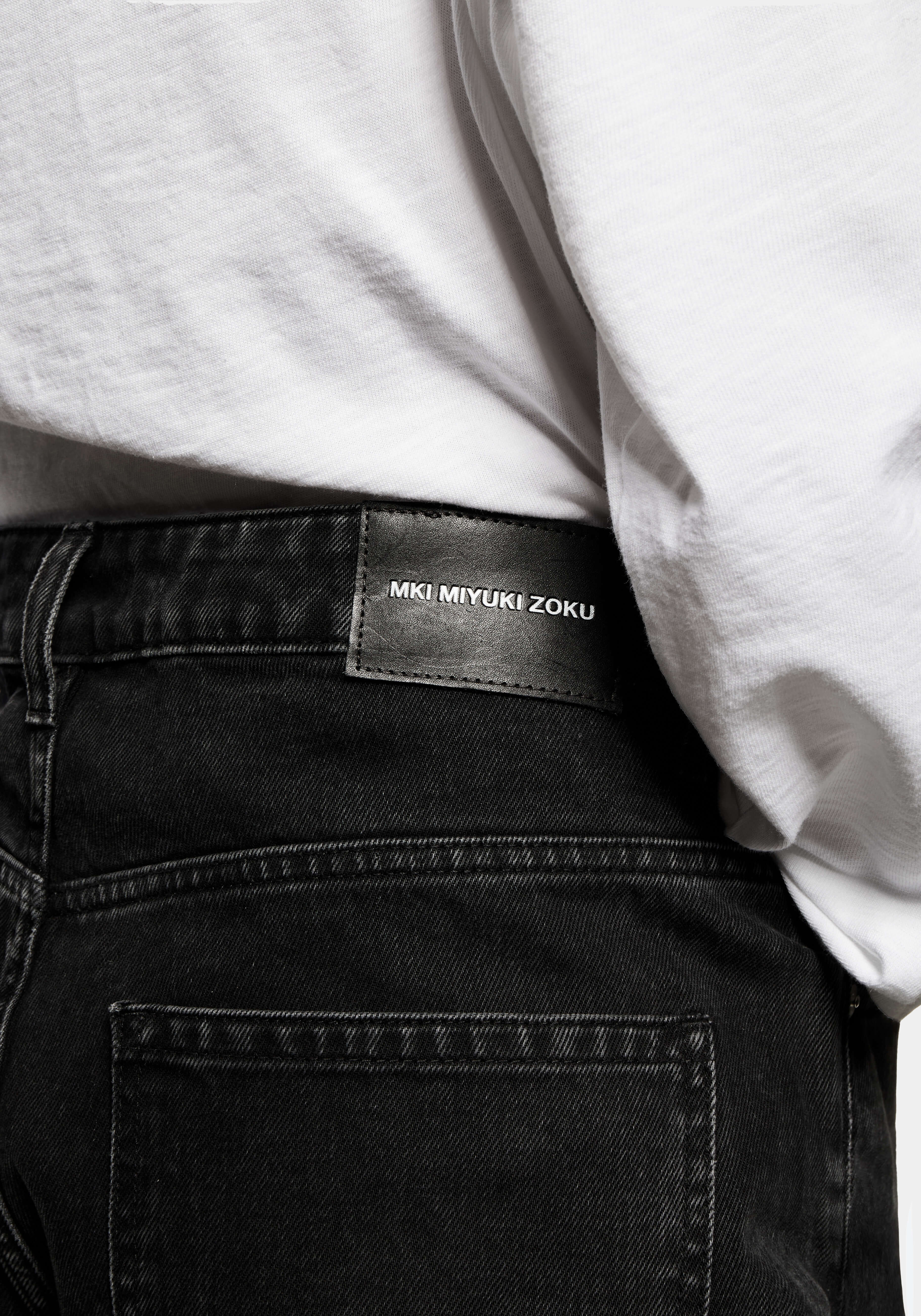 Close-up of the black leather MKI MIYUKI ZOKU patch at the back right waistband