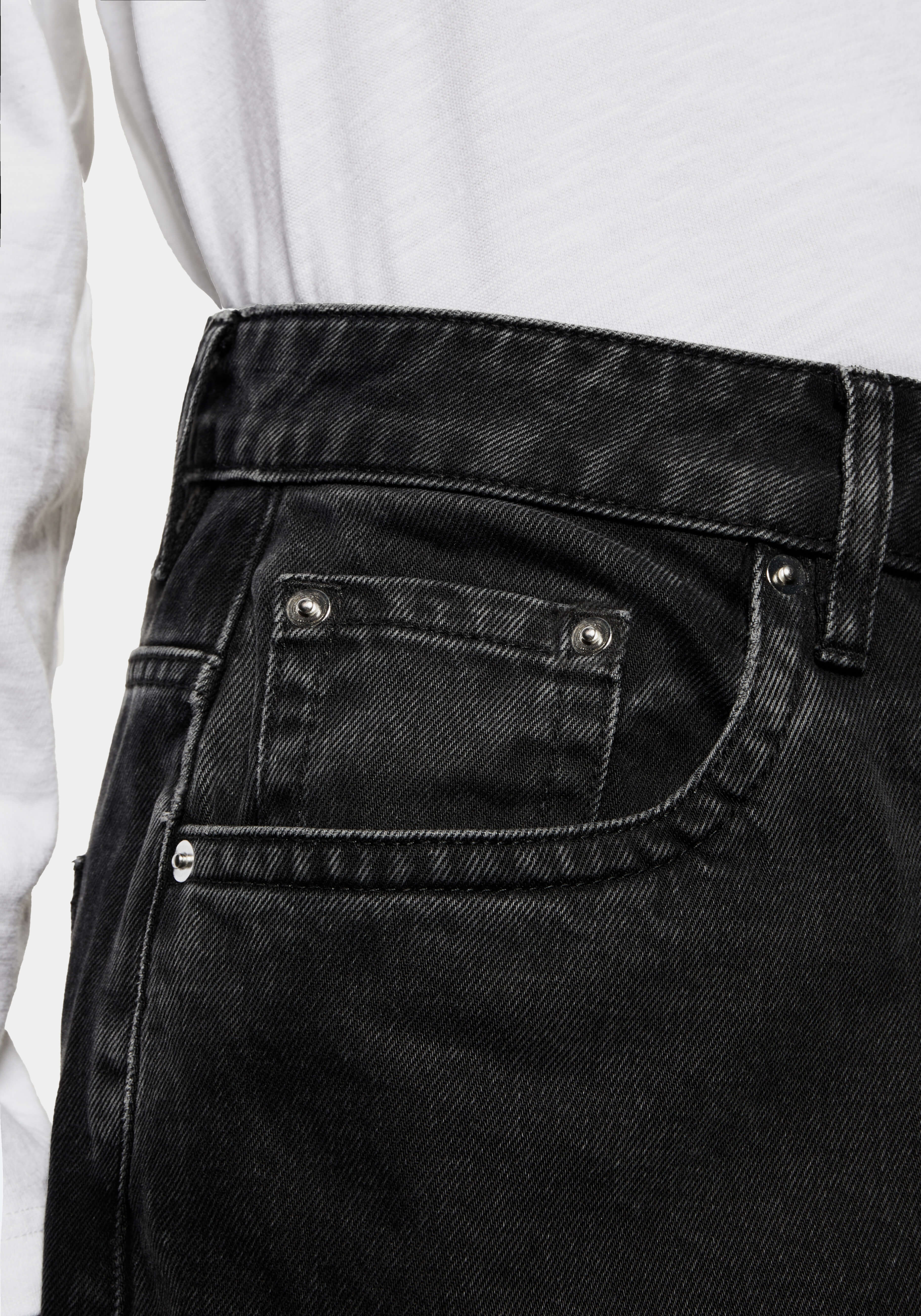 Close-up of the coin pocket and exposed rivets on the 14oz Black Wash denim
