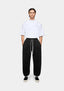 MKI MIYUKI ZOKU 800 GSM Superweight Cuffed Joggers in Black – full-length front view on the model showing the loose fit, contrast white drawstrings and elasticated cuffs