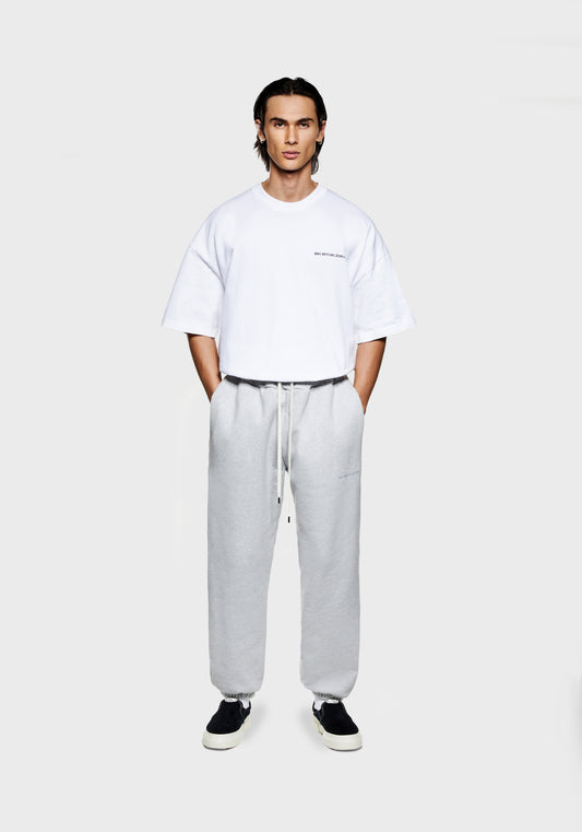 Full view of the MKI Superweight loose fit cuffed joggers in grey cotton jersey with minimal logo branding