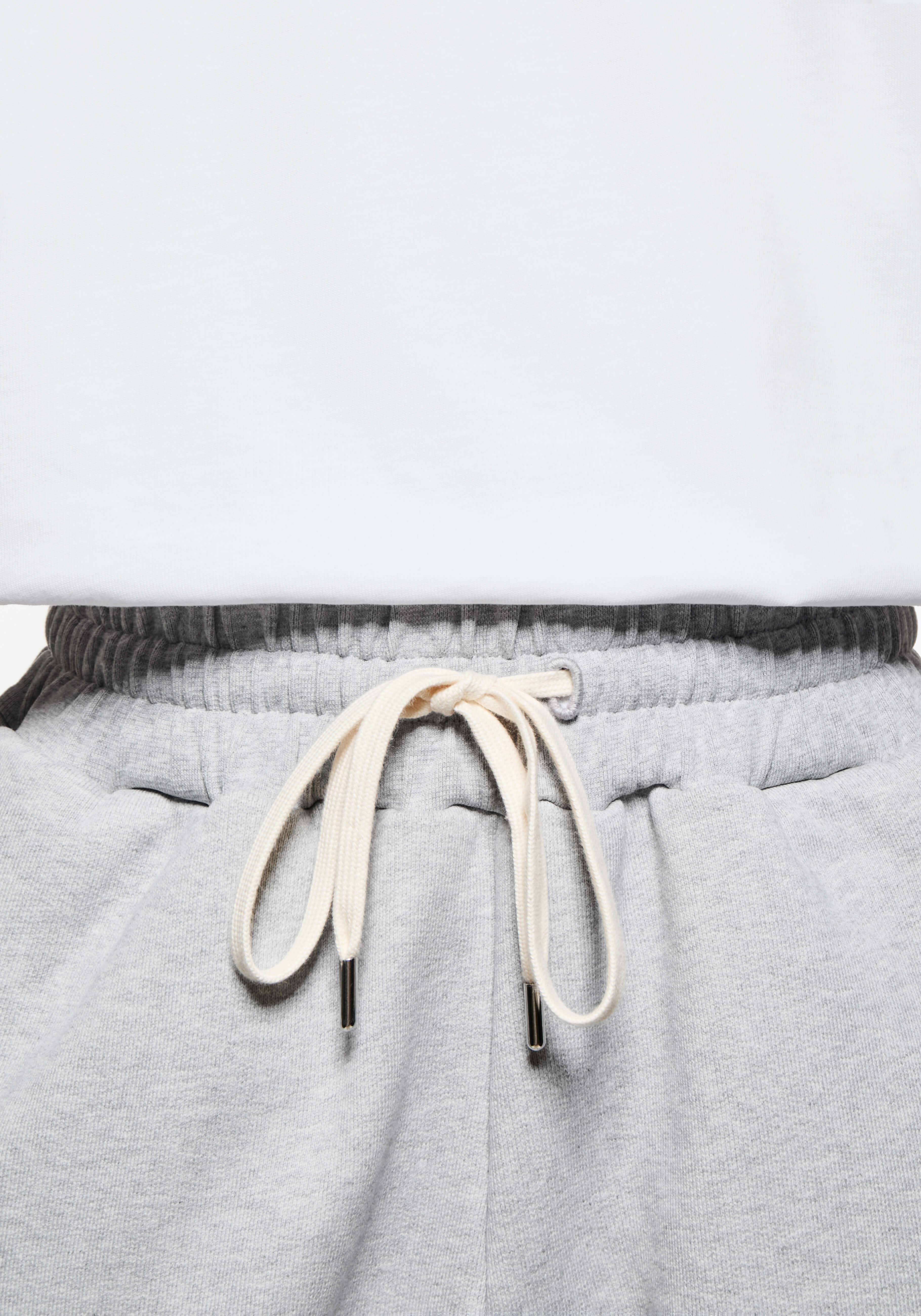Close-up of the elasticated waistband and cream metal-tipped drawstrings on the Grey Superweight Joggers