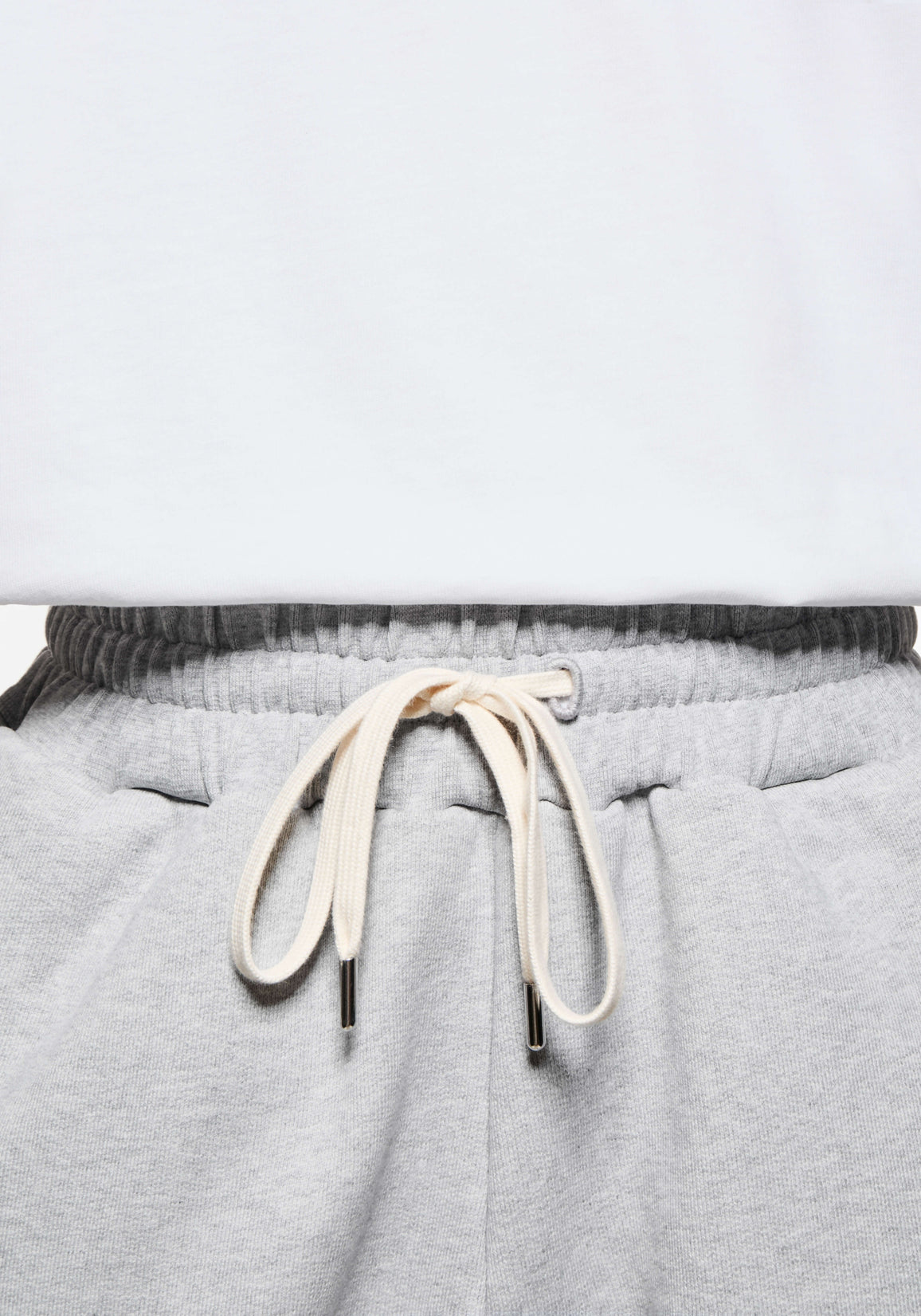 Close-up of the elasticated waistband and cream metal-tipped drawstrings on the Grey Superweight Joggers
