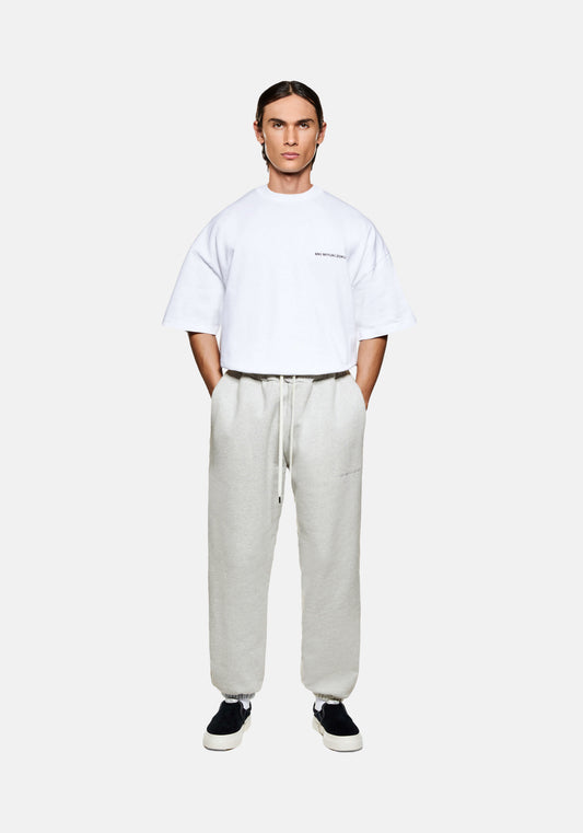 Full view of the MKI Superweight loose fit cuffed joggers in oatmeal cotton jersey with minimal logo branding