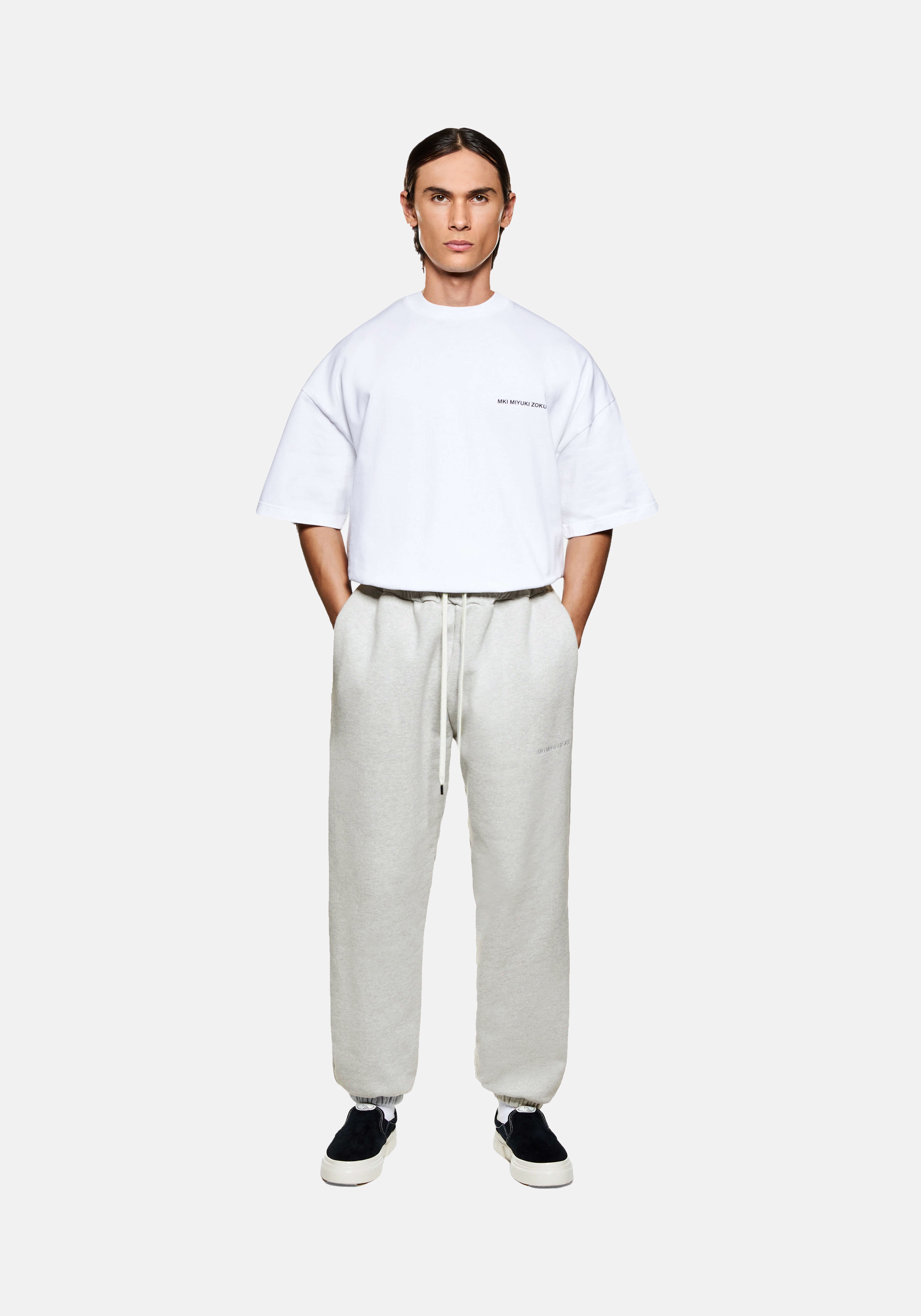 MKI MIYUKI ZOKU 800 GSM Superweight Cuffed Joggers in Oatmeal – full-length front view on the model showing the loose fit, cream drawstrings and elasticated cuffs
