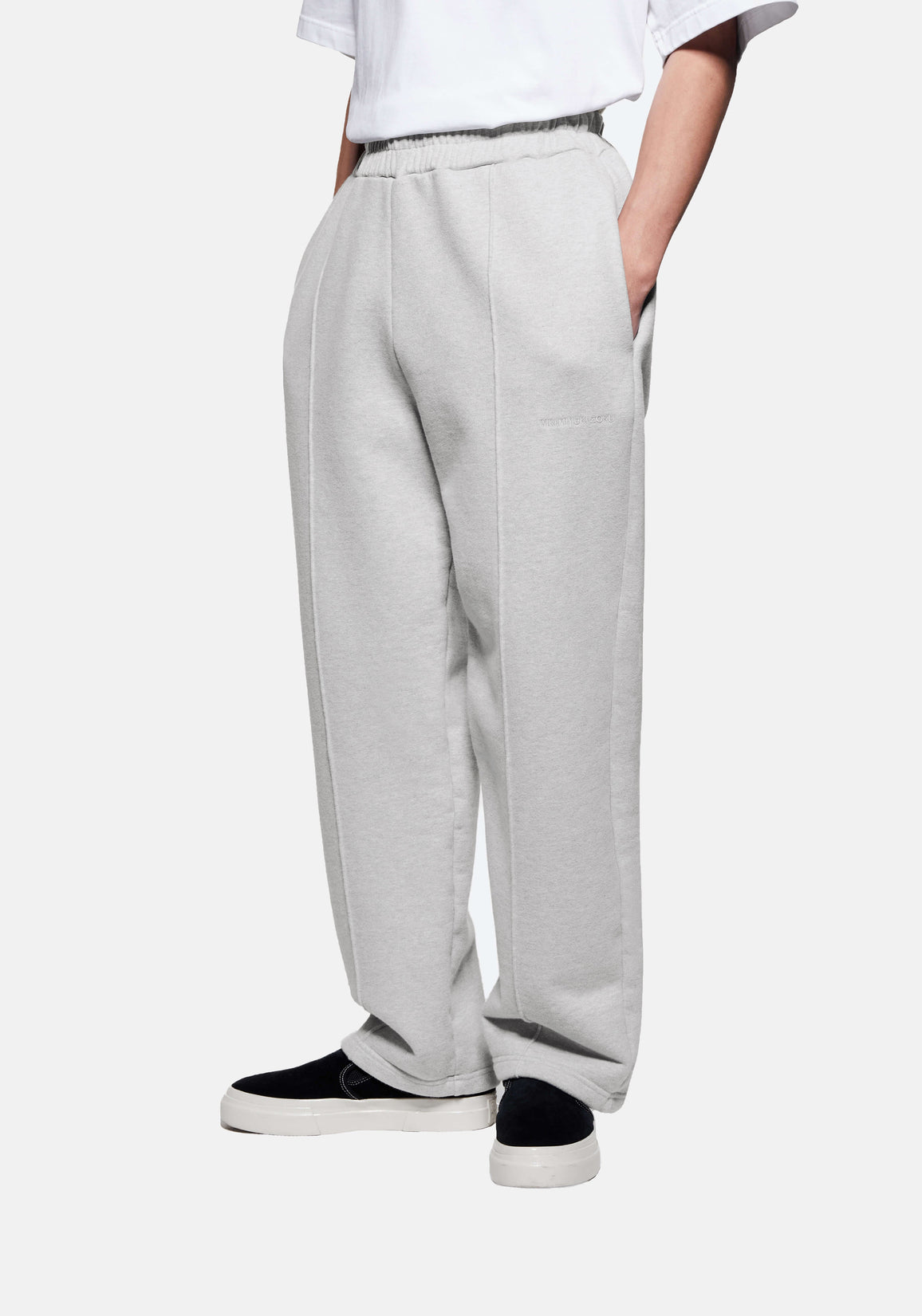 Front three-quarter view of the Grey Wide Leg Joggers showing the sewn-in pleat and heavy drape