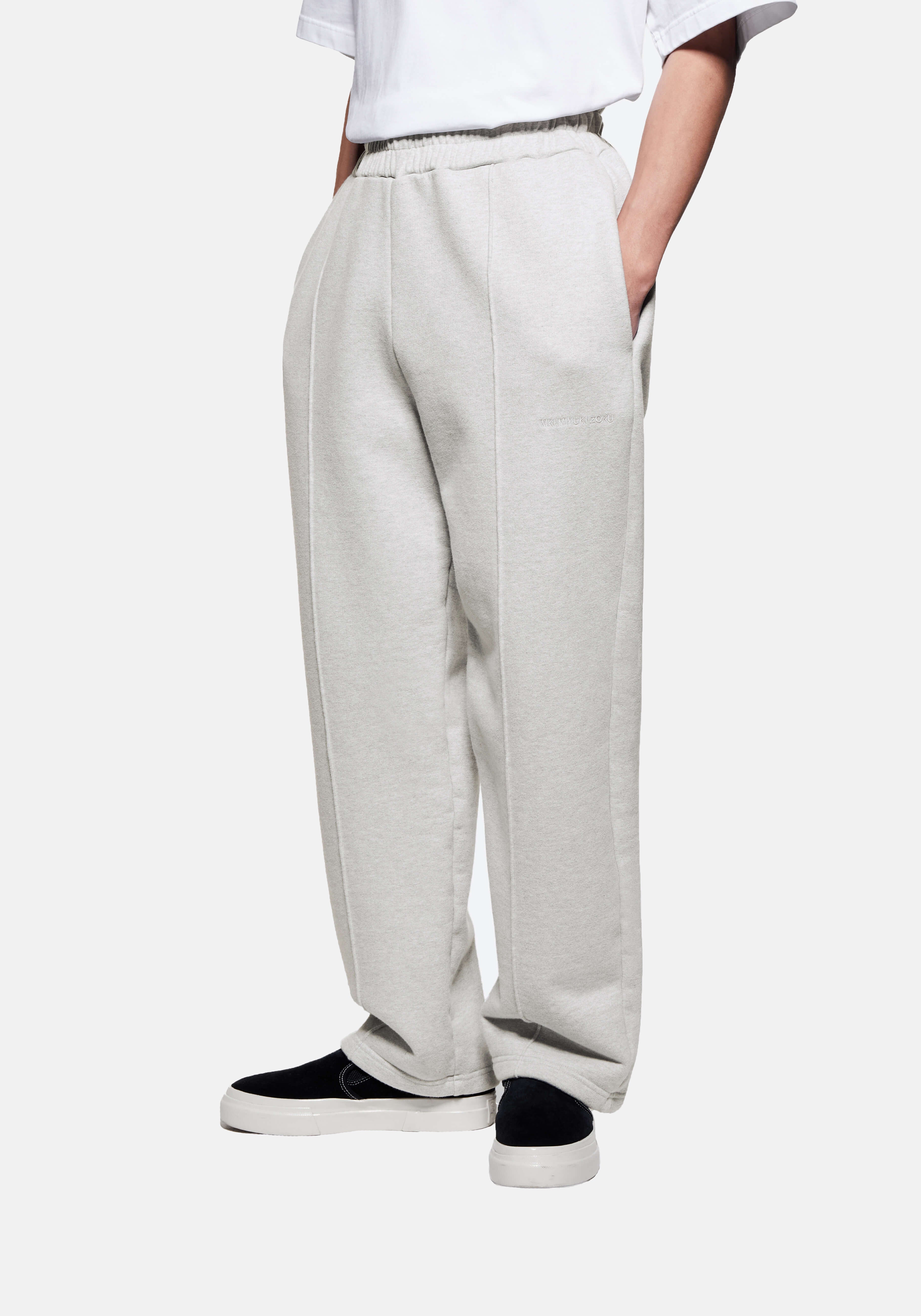 Front three-quarter view of the Oatmeal Wide Leg Joggers showing the sewn-in pleat and heavy drape