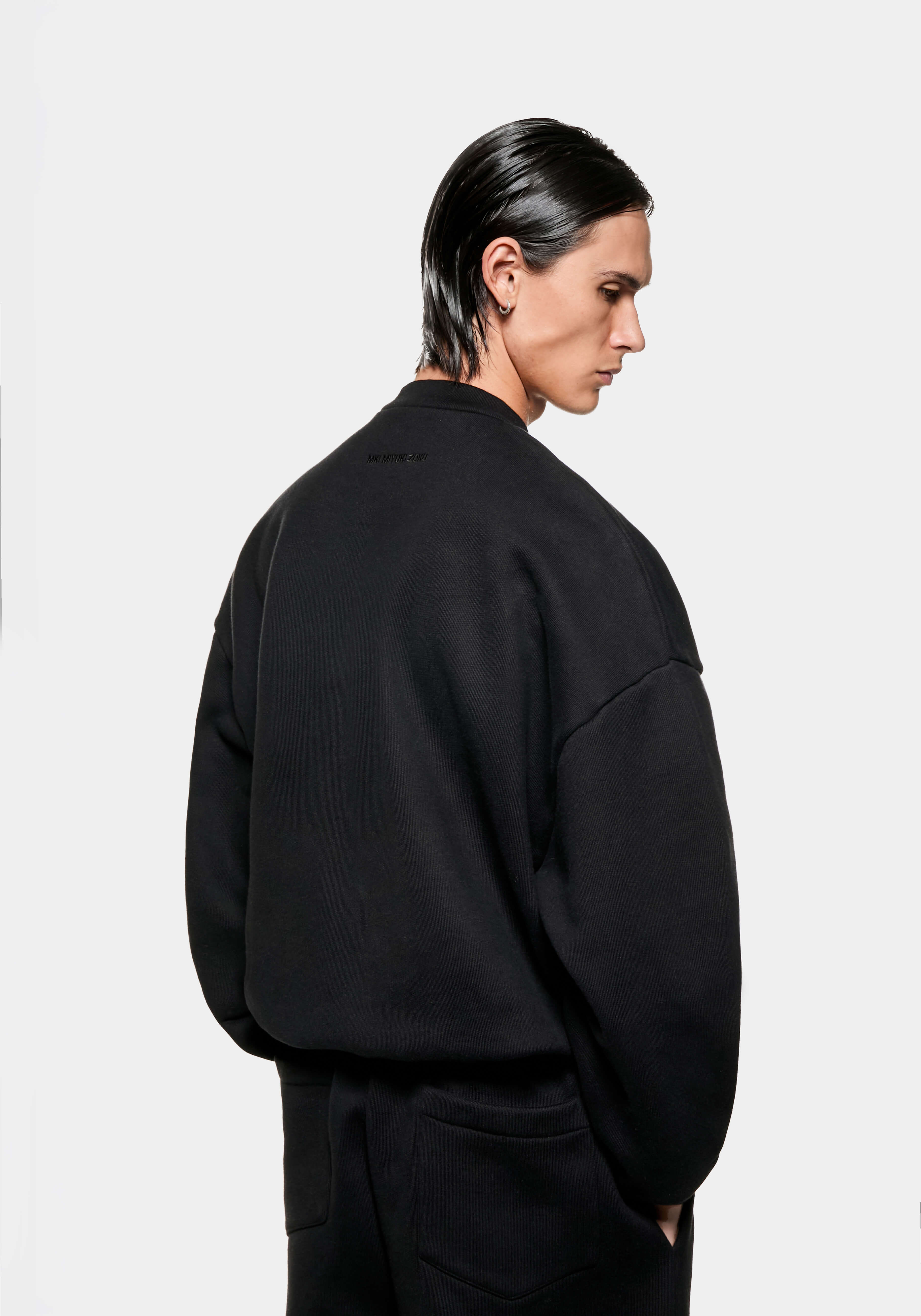 Back view of the black Superweight crewneck on the model, showing the boxy oversized shape