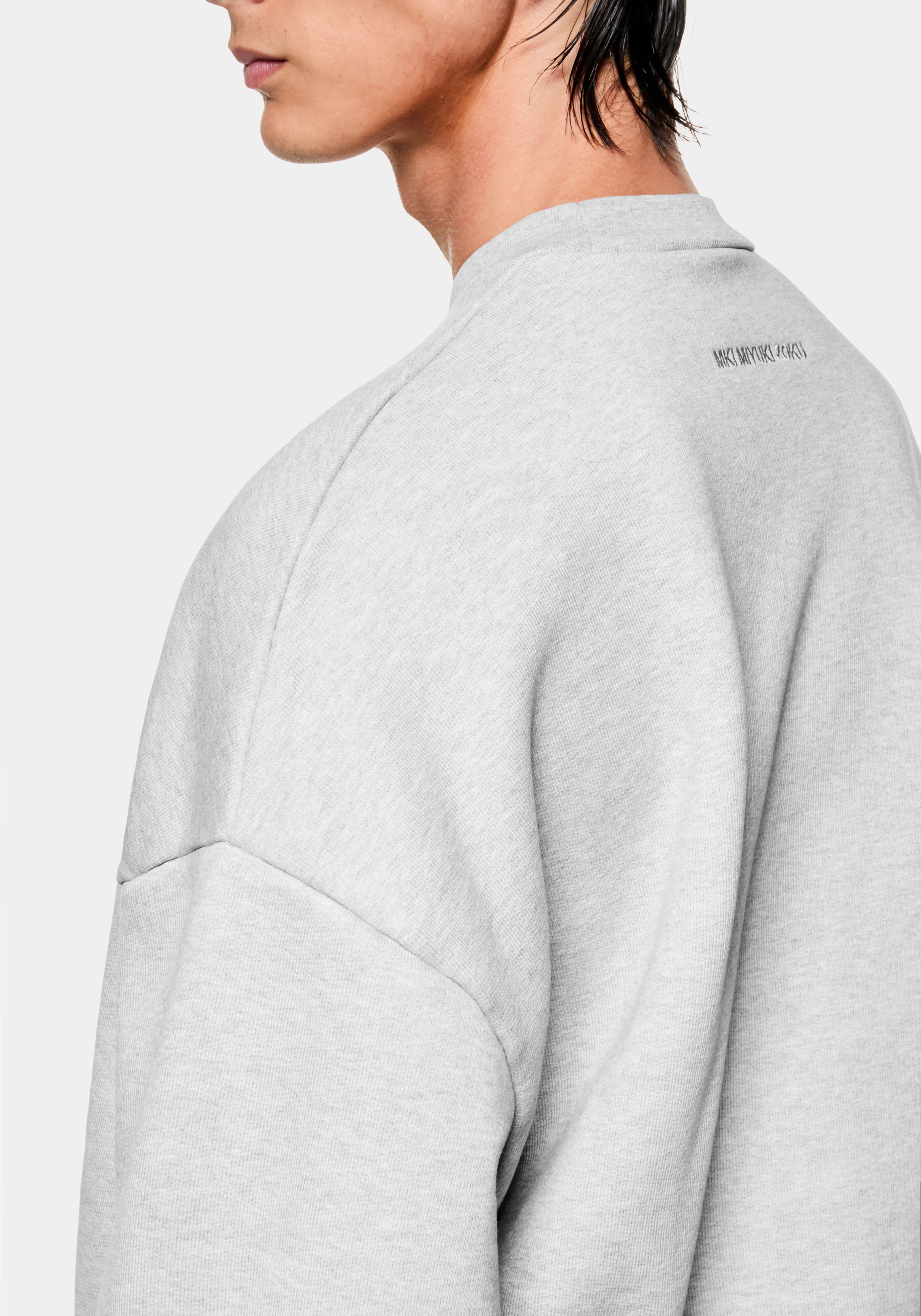 Close-up showing the dropped shoulders on the Superweight Crewneck in Grey