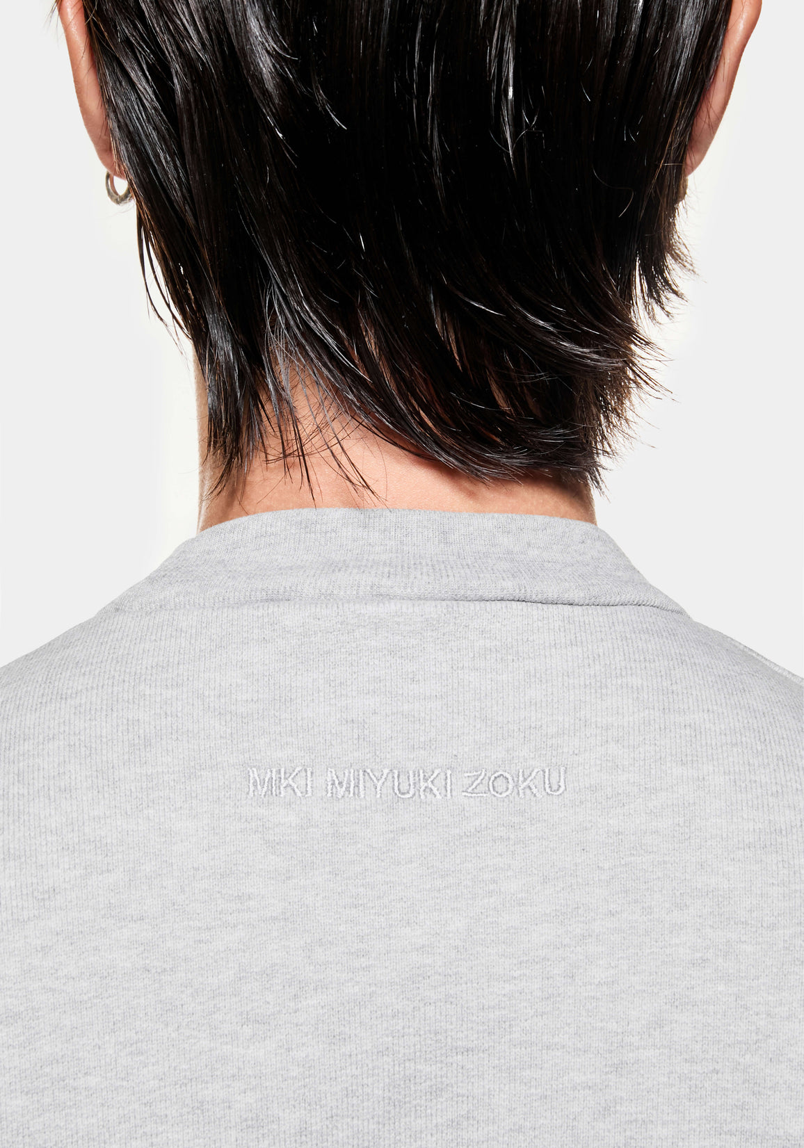 Close-up of the tonal logo on the Superweight Crewneck in Grey
