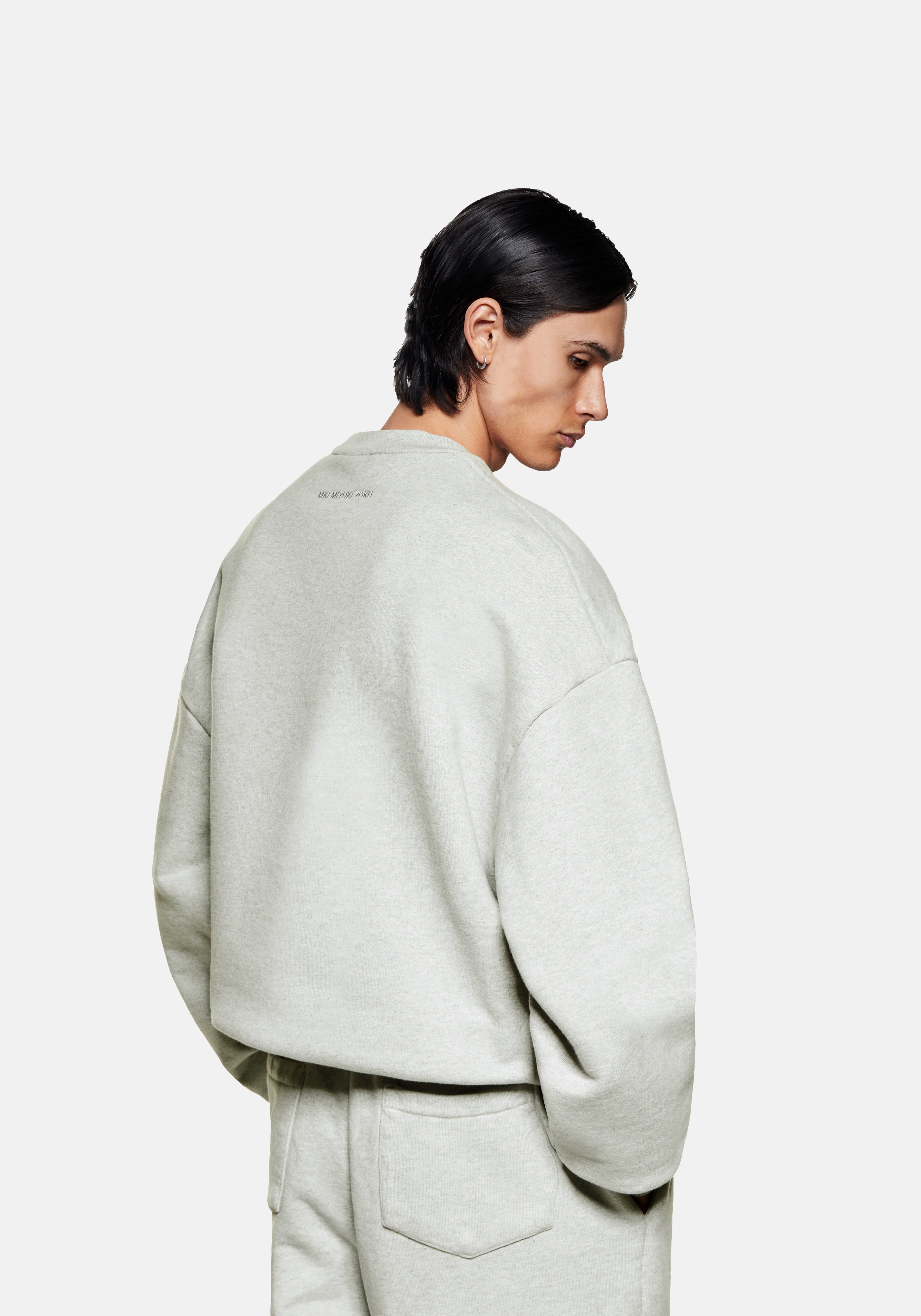 Back view of the oatmeal Superweight crewneck on the model, showing the boxy oversized shape