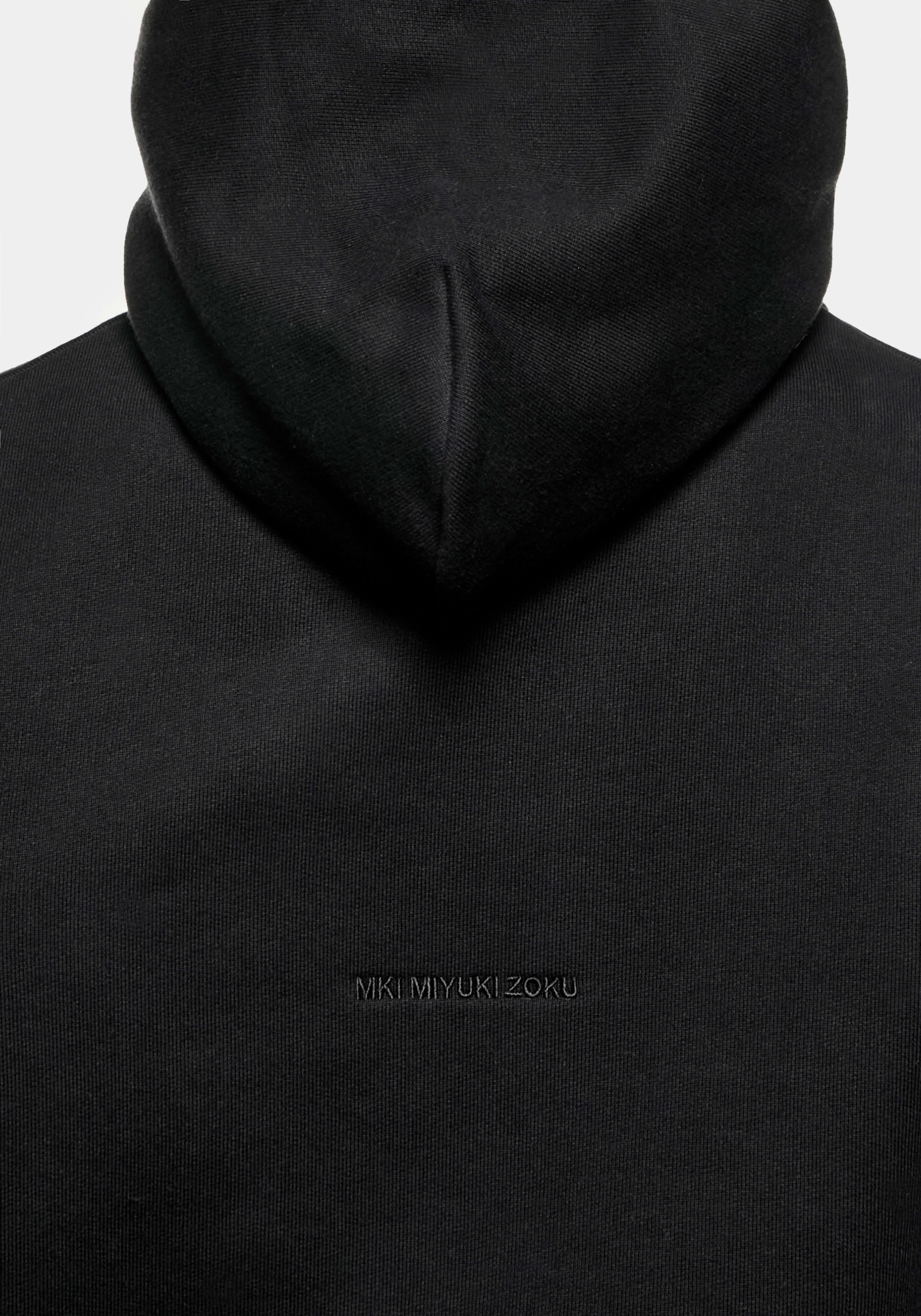 Close-up of the tonal logo embroidery on the Superweight Hoody in Black