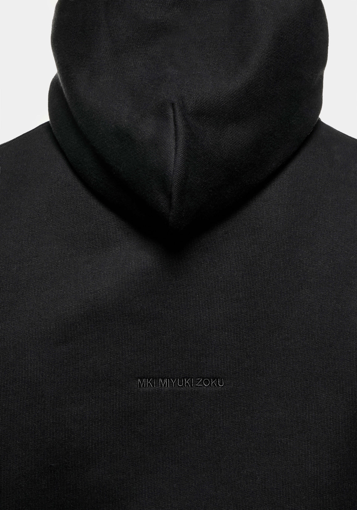 Close-up of the tonal logo embroidery on the Superweight Hoody in Black