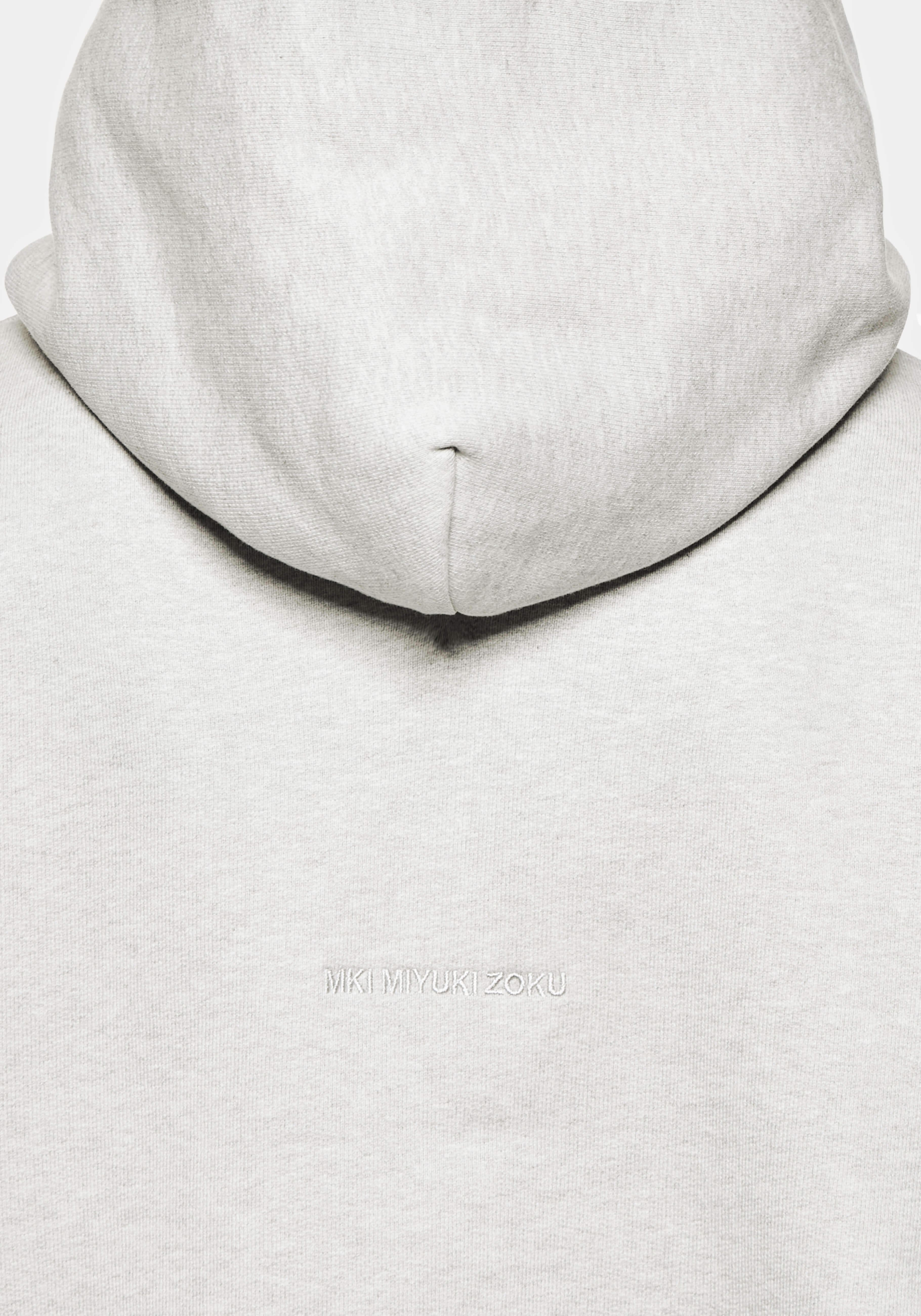 Close-up of the tonal logo embroidery on the Superweight Hoody in Oatmeal