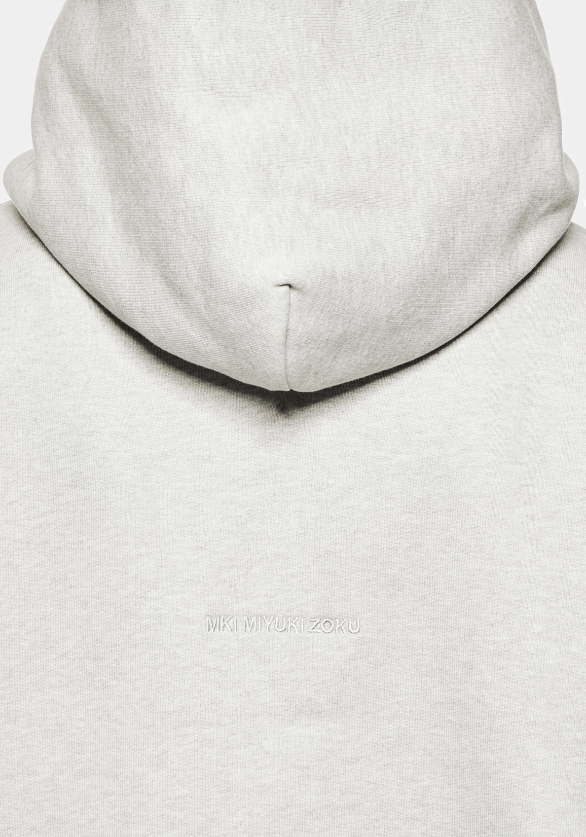 Close-up of the tonal logo embroidery on the Superweight Hoody in Oatmeal
