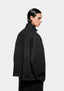 Back three-quarter view of the Black Superweight Quarter Zip showing the boxy shape