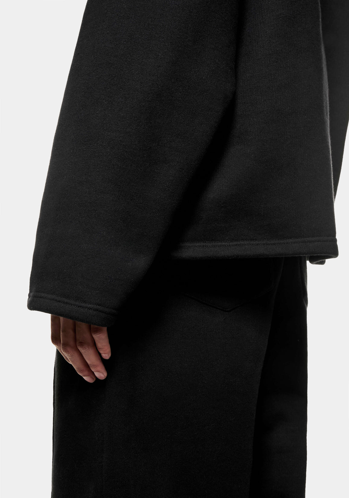 Close-up of the open cuff and hem on the Black Superweight Quarter Zip