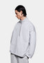 Three-quarter view of the Grey Superweight Quarter Zip showing the dropped shoulders and open hem