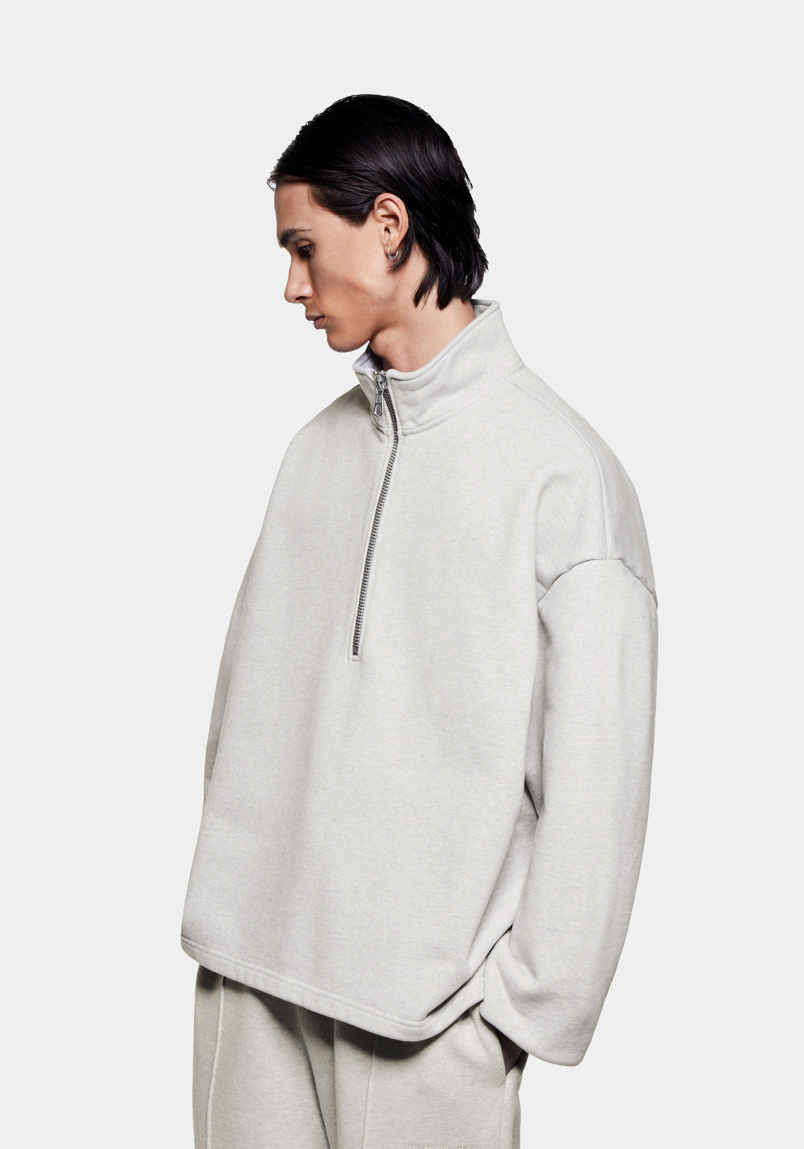 Three-quarter view of the Oatmeal Superweight Quarter Zip showing the dropped shoulders and open hem