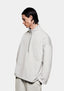 Three-quarter view of the Oatmeal Superweight Quarter Zip showing the dropped shoulders and open hem